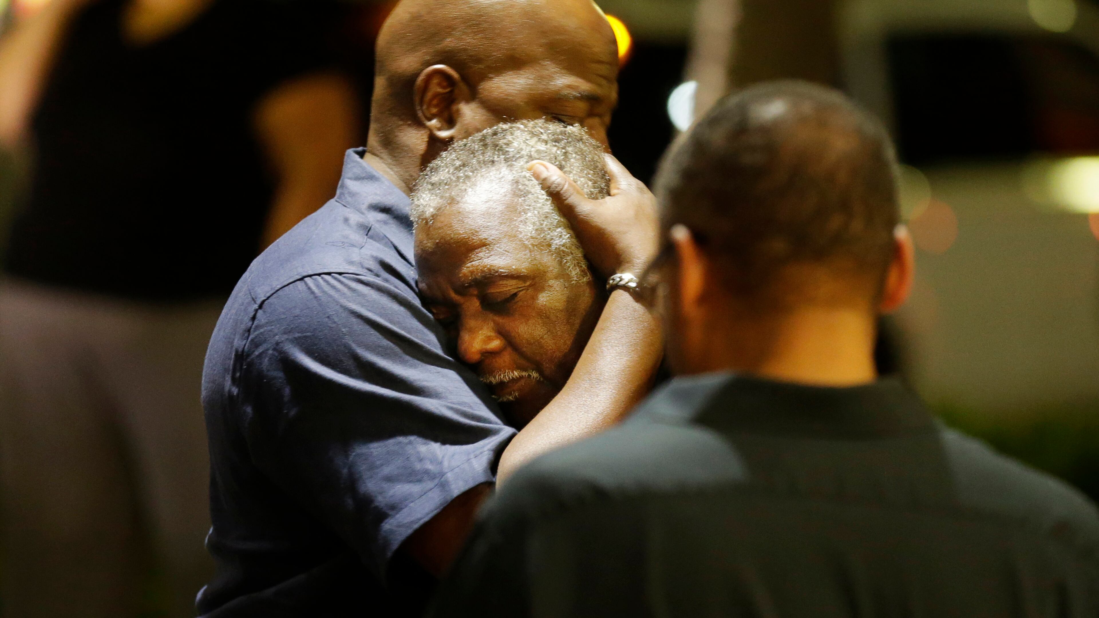 Worshippers embrace following a group prayer across the street from the scene of a shooting June 17, 2015, in Charleston, S.C.