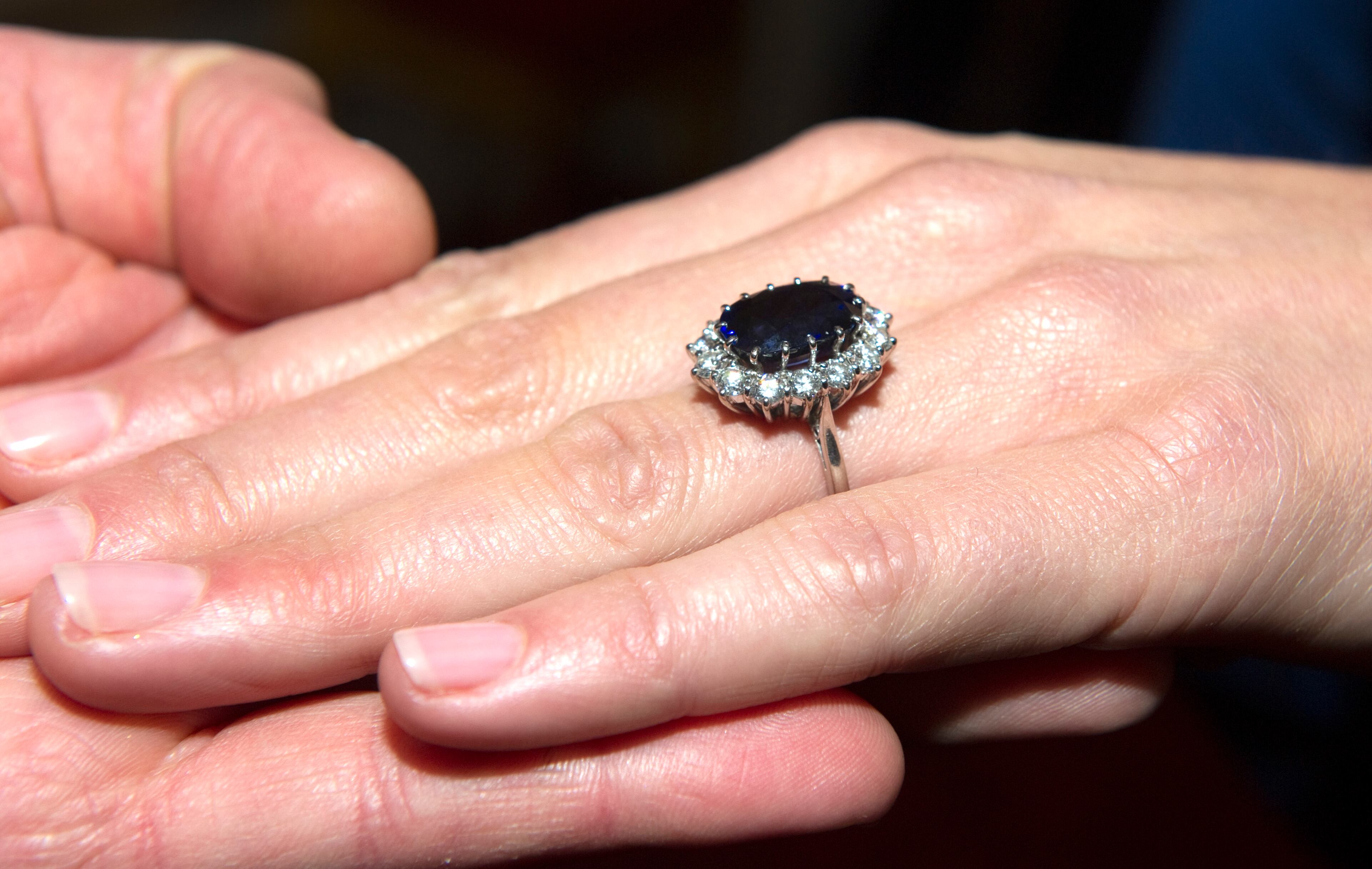 A close up of Kate Middleton's engagement ring as she poses for photographs in the State Apartments with her fiance Prince William of St James Palace on November 16, 2010 in London, England. After much speculation, Clarence House today announced the engagement of Prince William to Kate Middleton. The couple will get married in either the Spring or Summer of next year and continue to live in North Wales while Prince William works as an air sea rescue pilot for the RAF. The couple became engaged during a recent holiday in Kenya having been together for eight years. (Photo by Arthur Edwards - WPA Pool/Getty Images)