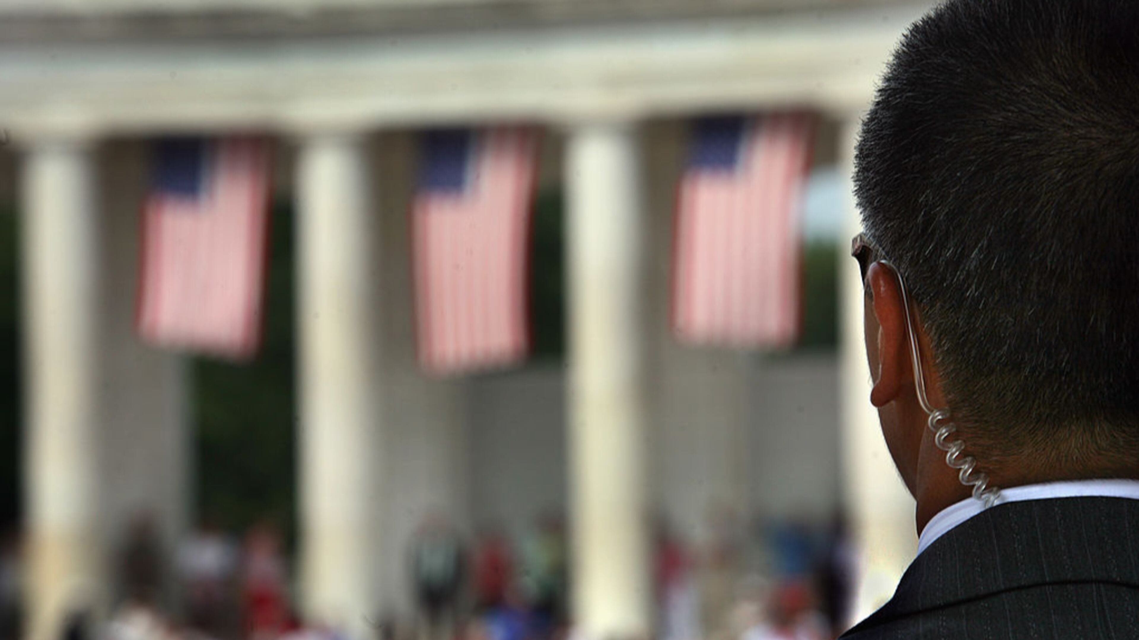 A Secret Service agent scans the crowd at the amphitheater at Arlington National Cemetery during a Memorial Day event. An agent with Vice President Mike Pence’s detail has been suspended after being caught with a prostitute.