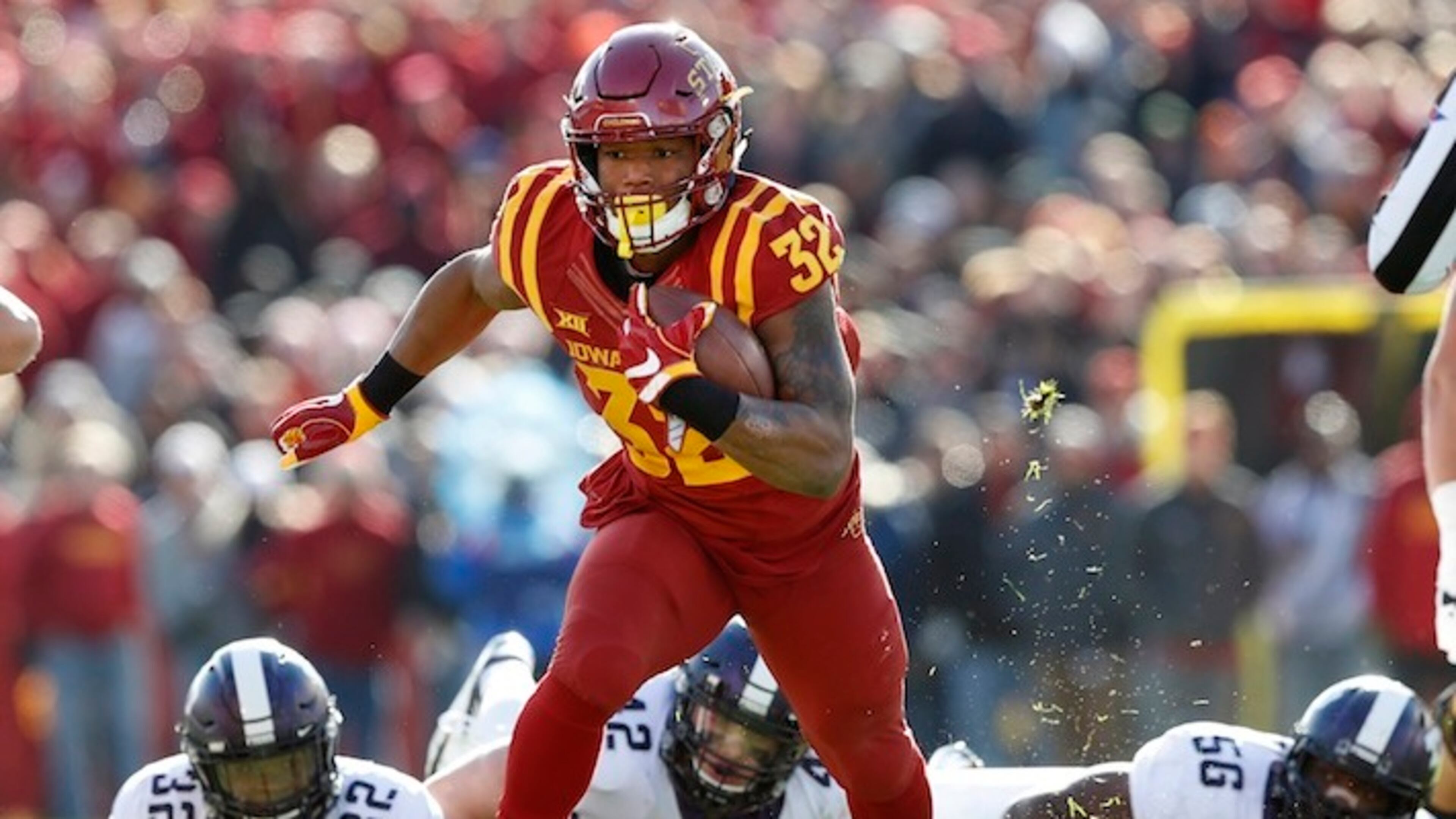 Iowa State running back David Montgomery runs from TCU defenders Travin Howard (32), Ty Summers (42) and Chris Bradley (56) during the first half of an NCAA college football game, Saturday, Oct. 28, 2017, in Ames, Iowa. Iowa State won 14-7. (AP Photo/Charlie Neibergall)