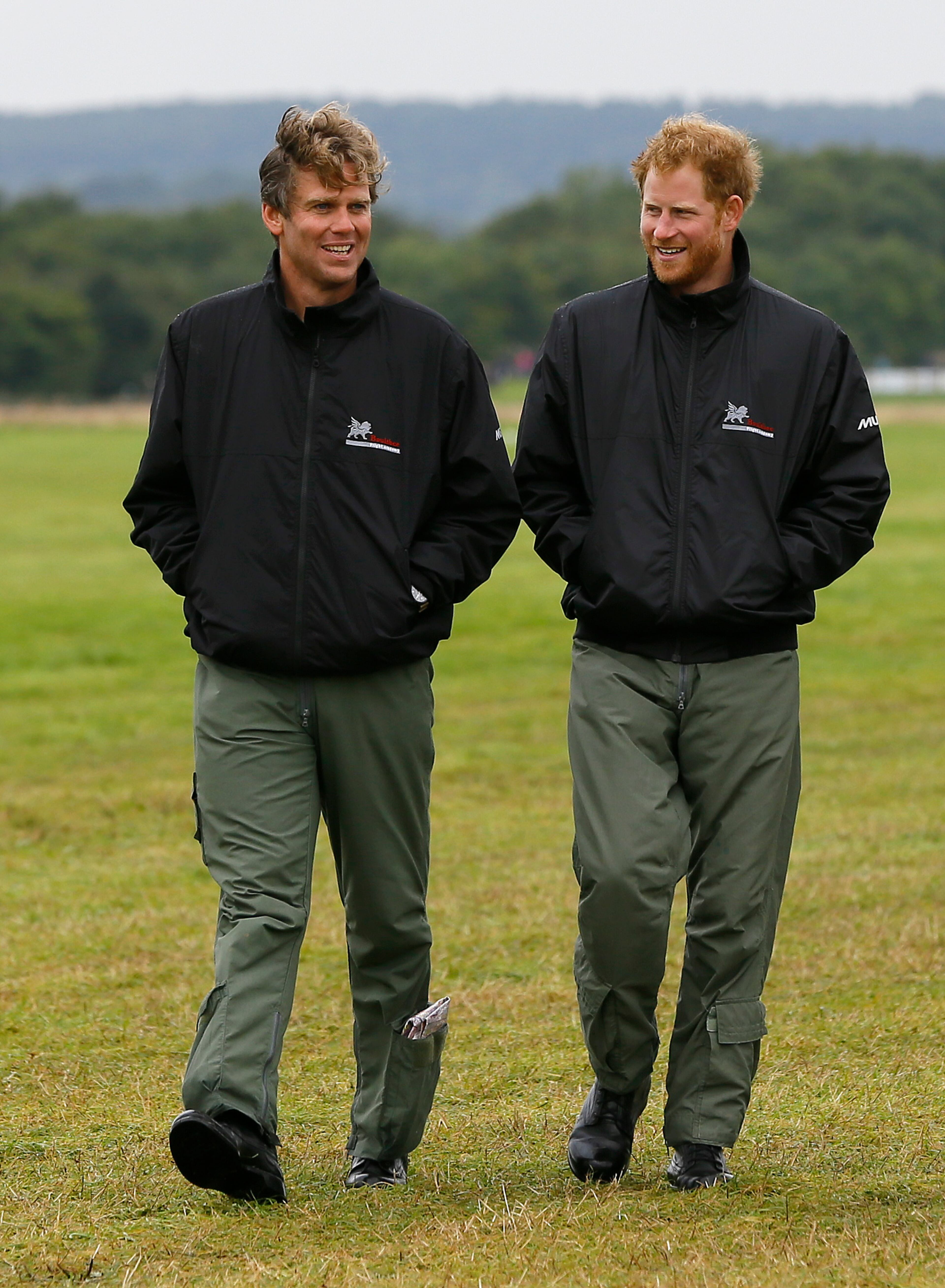 CHICHESTER, ENGLAND - SEPTEMBER 15: Prince Harry walks with Matt Jones, right, Director of Boultbee Flight Academy past the Battle of Britain aircraft on the airfield at Goodwood Aerodrome on September 15, 2015 in Chichester, England. The 75th Anniversary of the Battle of Britain is being marked by a historic flypast that brings more Battle of Britain aircraft together than ever before as a show of thanks to 'the few' and the sacrifices they made. (Photo by Kirsty Wigglesworth - Pool/Getty Images)