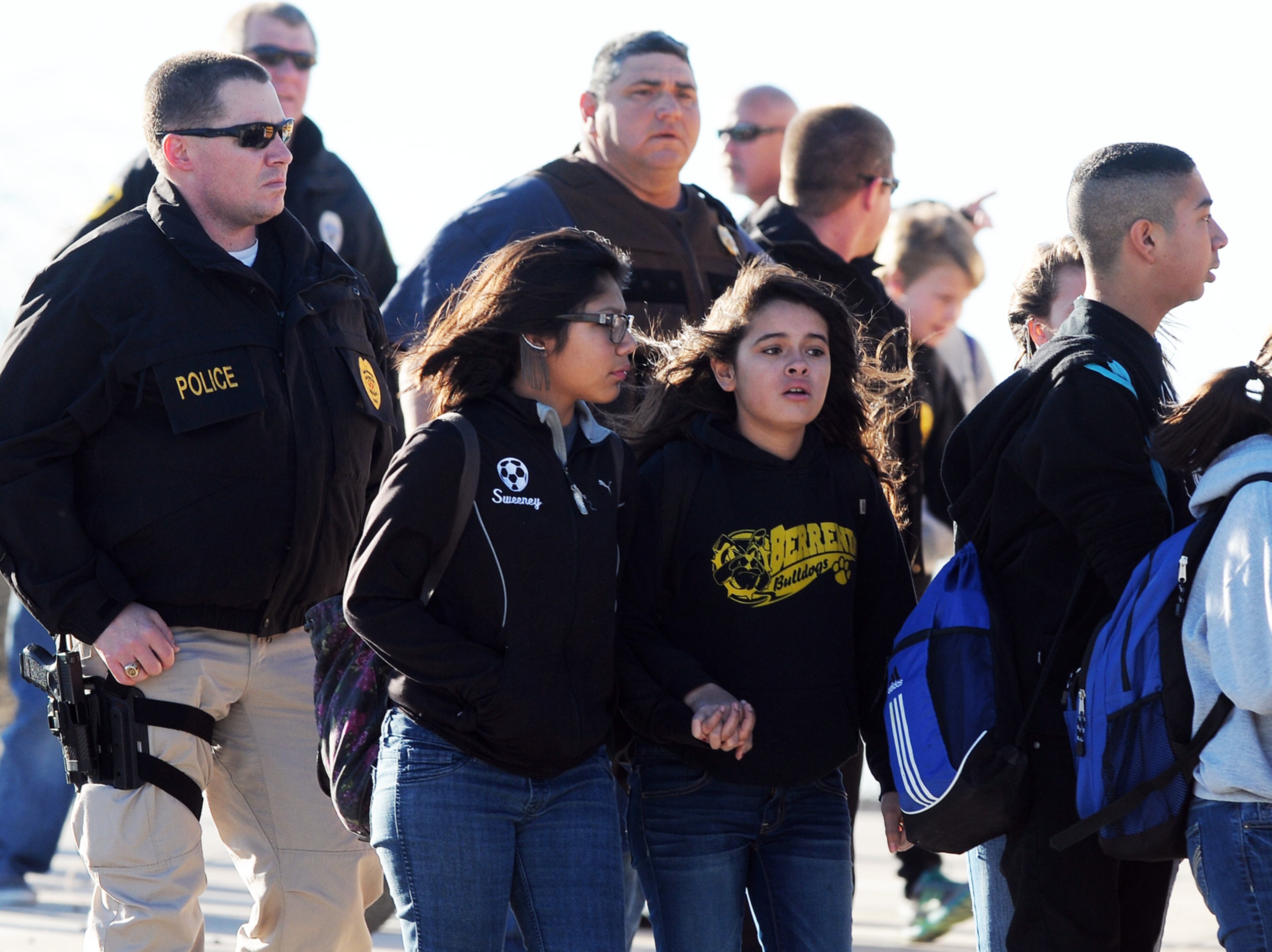 Students surrounded by officials are escorted from Berrendo Middle School after a shooting on Jan. 14, 2014, in Roswell, N.M.