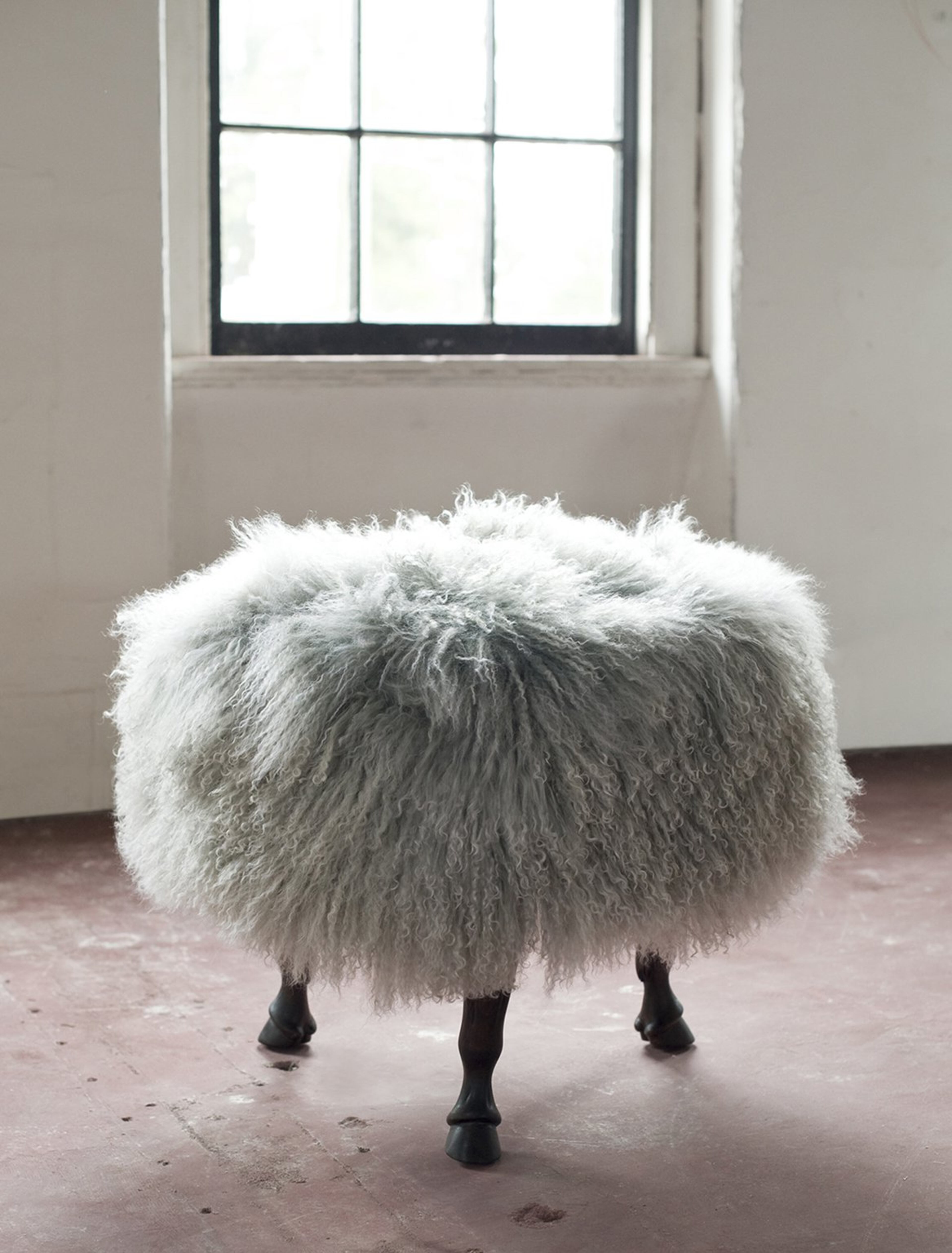 The Tibetan wool-covered ottoman sits on three carved horse hoof legs. Designed and made in North Carolina by vanCollier, the whimsical Finn Ottoman is available in custom sizes and finishes. Contributed by www.vanCollier.com