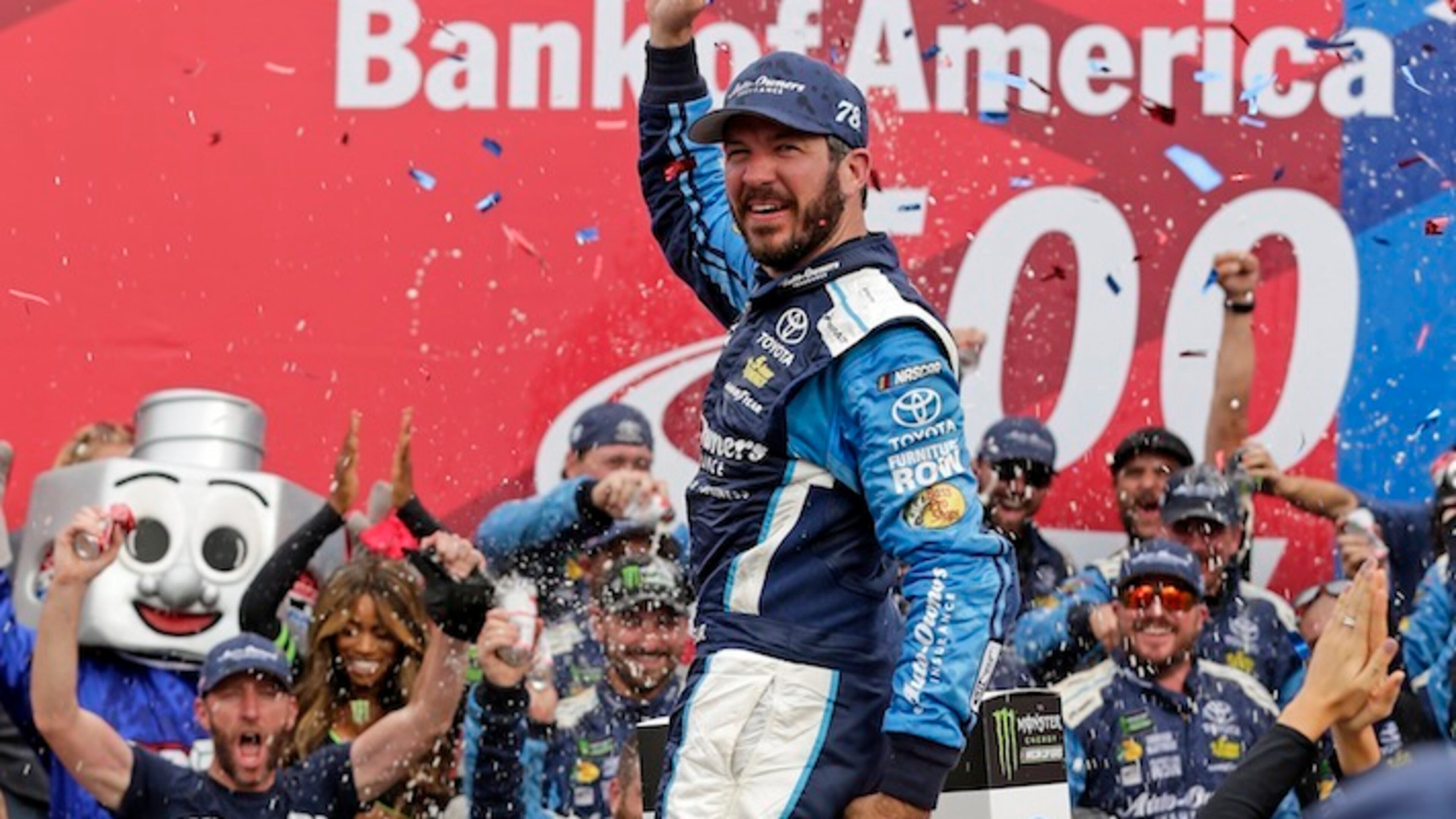 Martin Truex Jr celebrates in Victory Lane after winning a NASCAR Cup Series auto race at Charlotte Motor Speedway in Concord, N.C., Sunday, Oct. 8, 2017. (AP Photo/Chuck Burton)