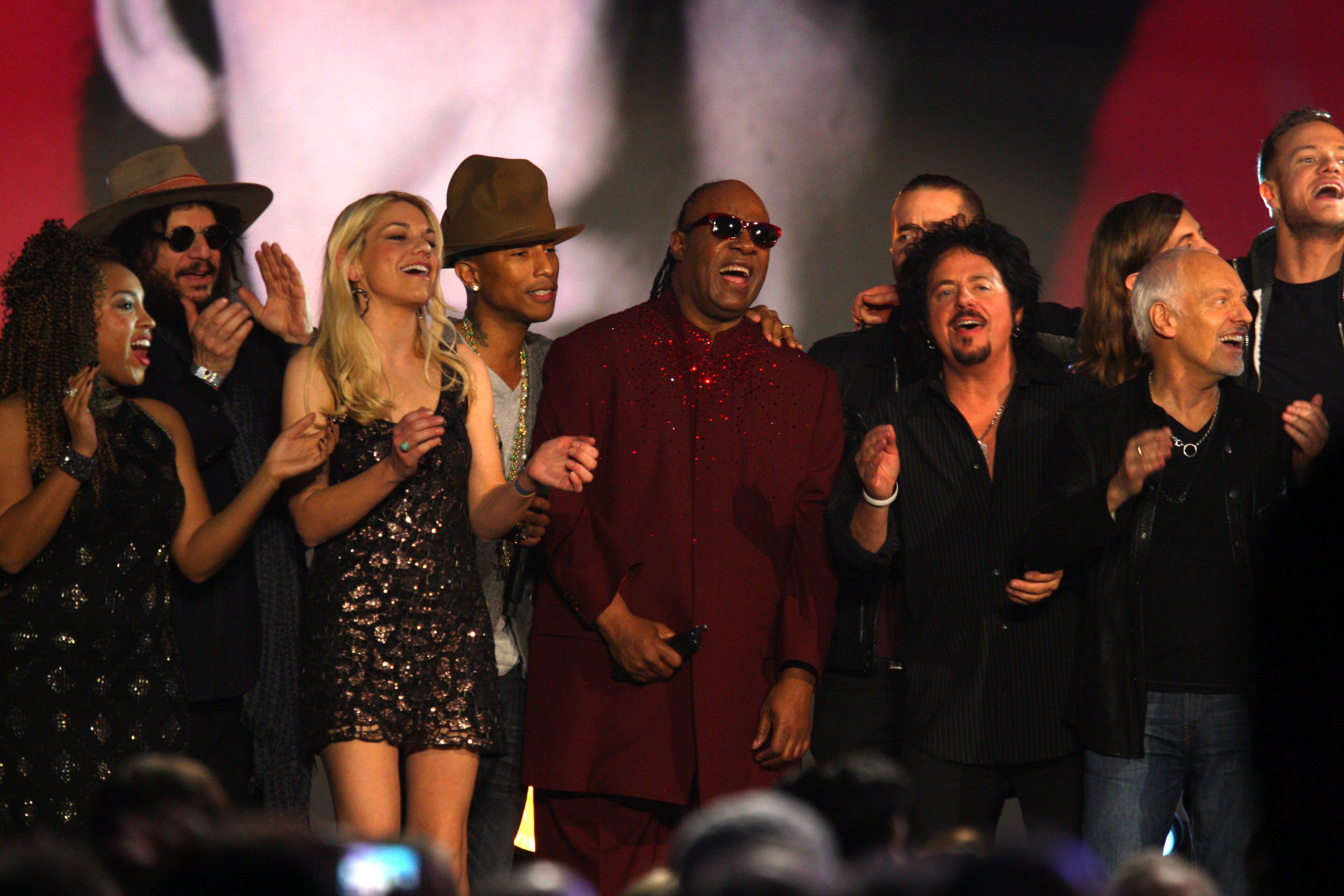 Pharrell Williams, fourth from left, and Stevie Wonder, center, perform at The Night that Changed America: A Grammy Salute to the Beatles, on Monday, Jan. 27, 2014, in Los Angeles. (Photo by Zach Cordner/Invision/AP)
