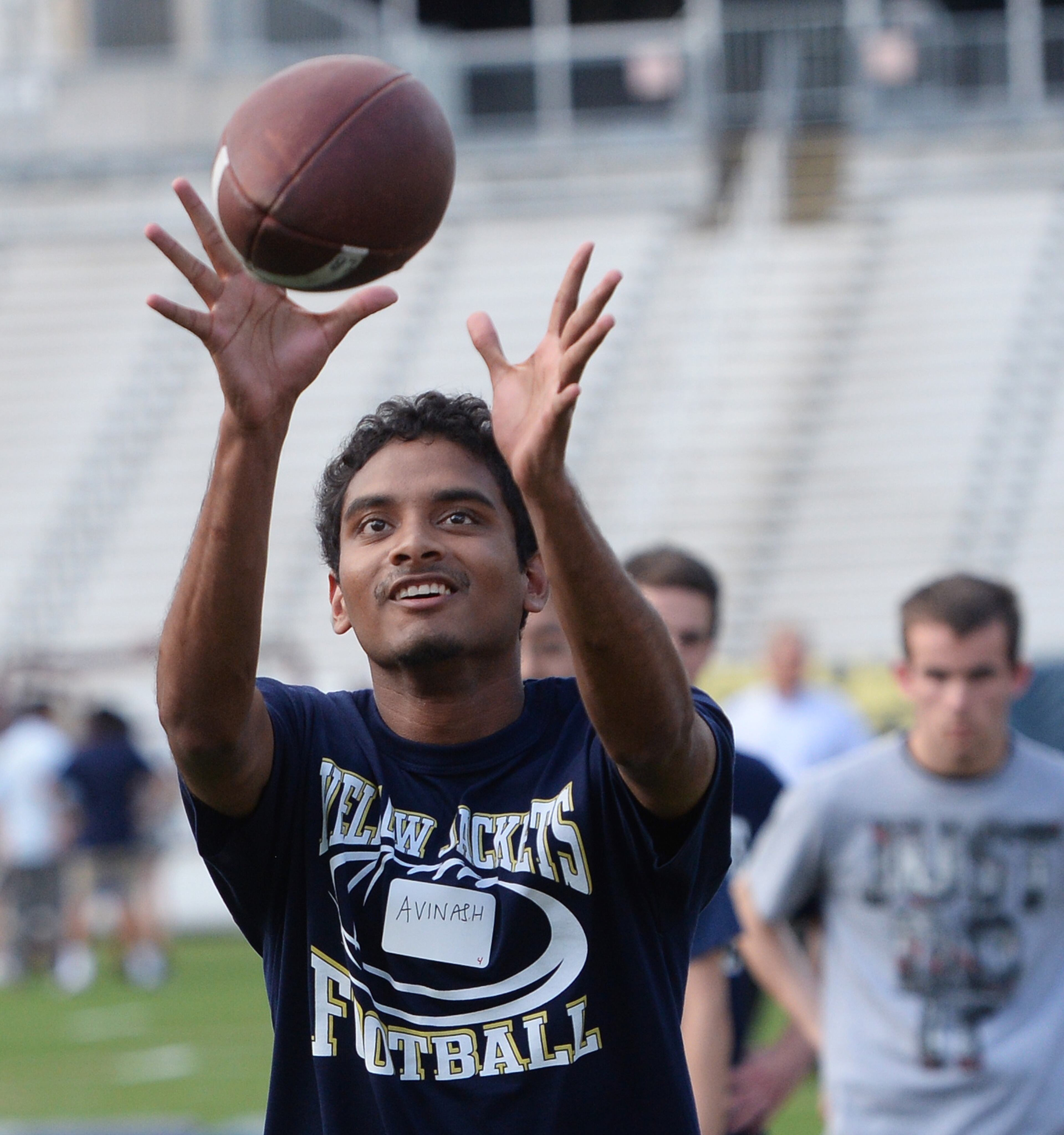 M. Avinash, Singapore, tries to catch a football.
