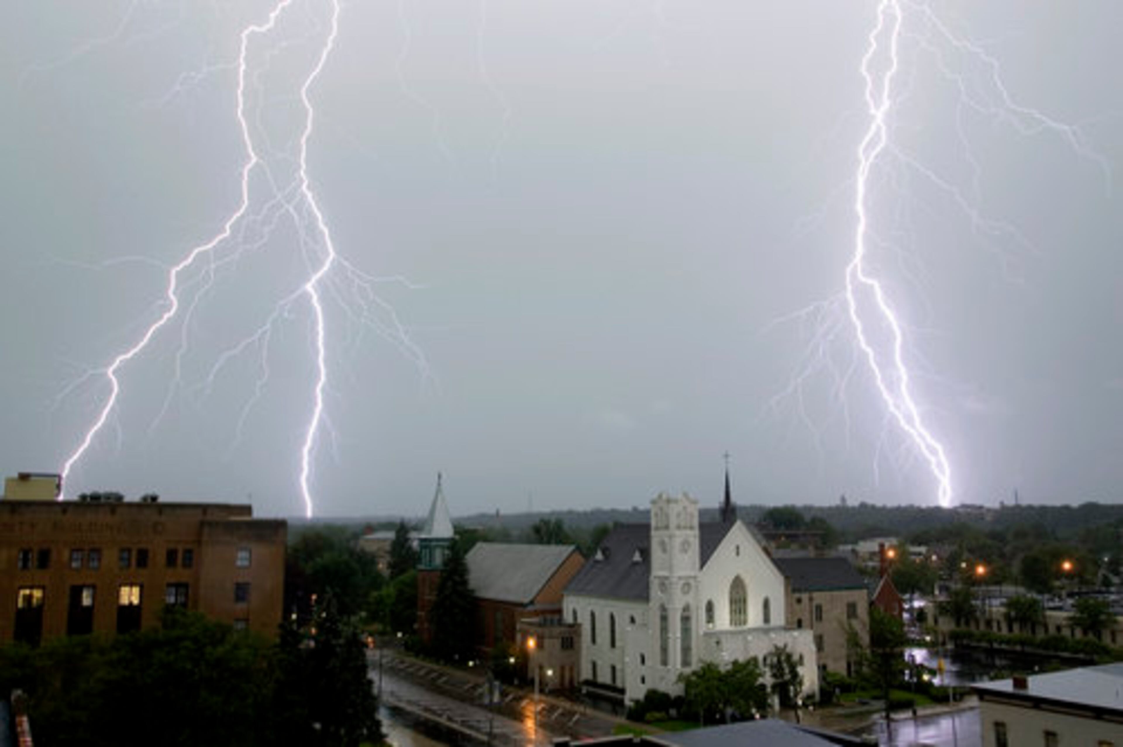 Lightning flashes across the downtown skyline above the First Baptist Church in Kalamazoo, Mich., on Wednesday.
