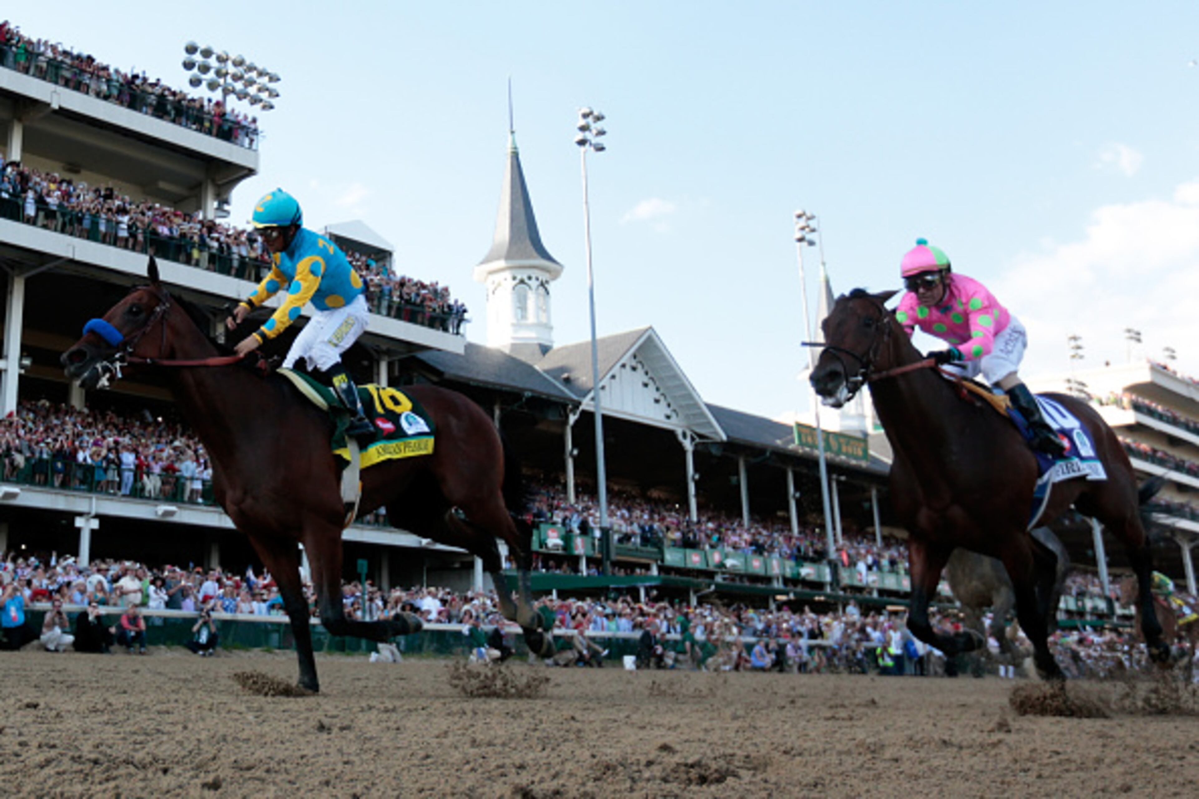 LOUISVILLE, KY - MAY 02: Jockey Victor Espinoza celebrates as he guides American Pharoah #18 after crossing the finish line to win the 141st running of the Kentucky Derby at Churchill Downs on May 2, 2015 in Louisville, Kentucky. (Photo by Rob Carr/Getty Images)