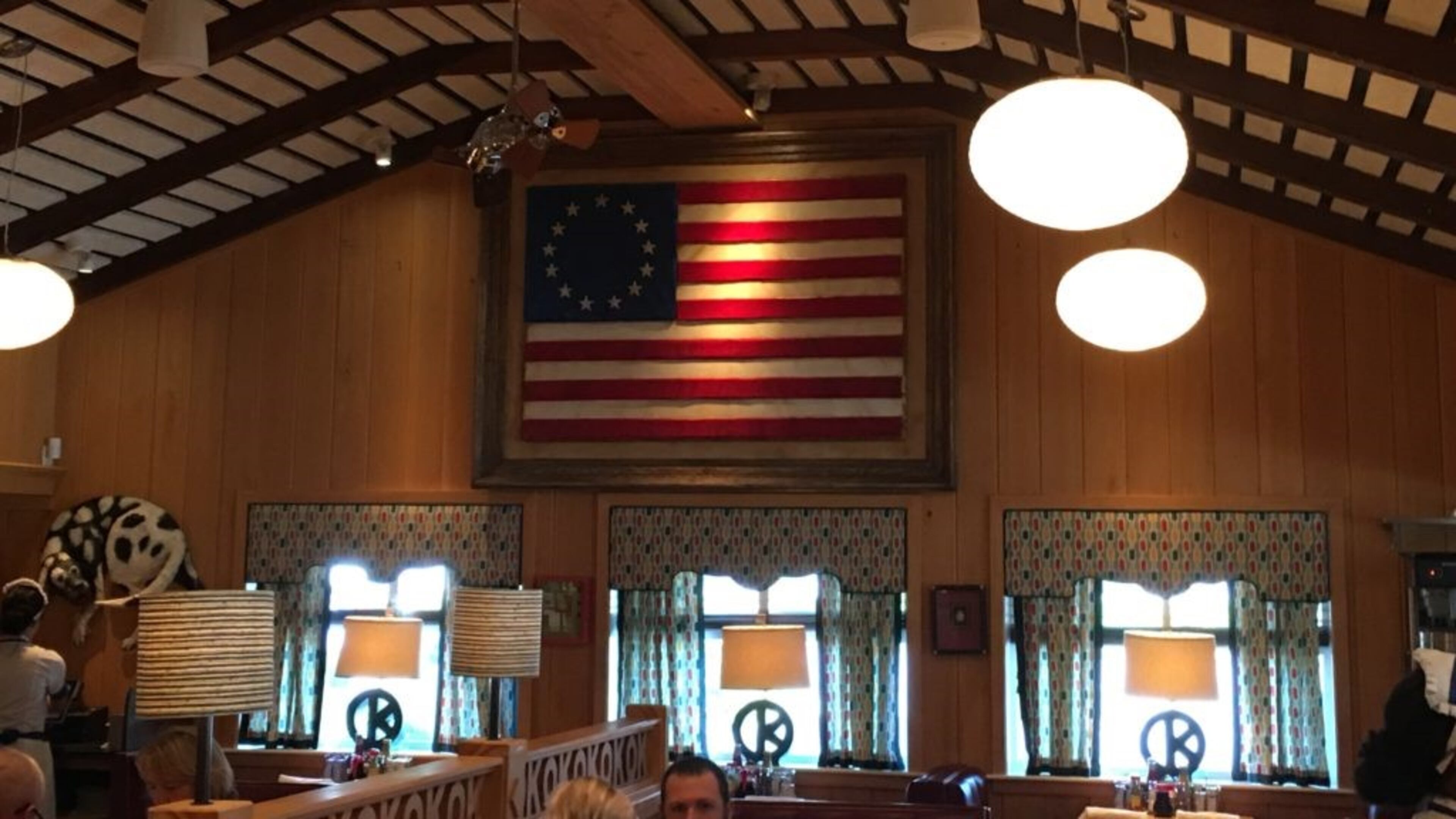 OK Cafe's owners recently replaced a wood-carving of the 1956 Georgia flag with artwork depicting the Besty Ross American flag with 13 stars in a circle. Courtesy of Tony Wilbert.