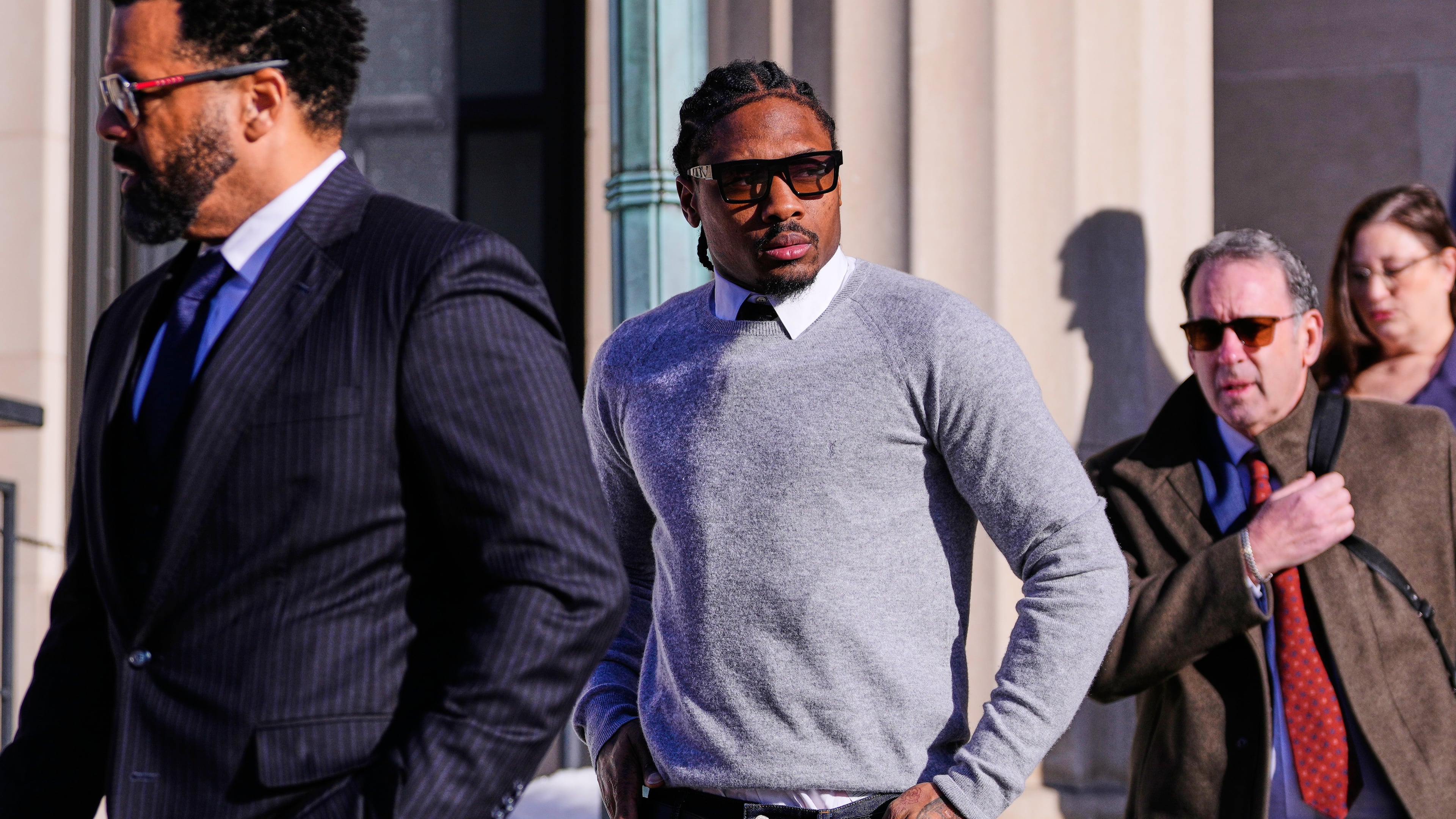 FILE - New England Patriots wide receiver Stefon Diggs leaves Norfolk County District Court after his arraignment on felony strangulation and a misdemeanor assault charges, Feb. 13, 2026, in Dedham, Mass. (AP Photo/Charles Krupa, File)