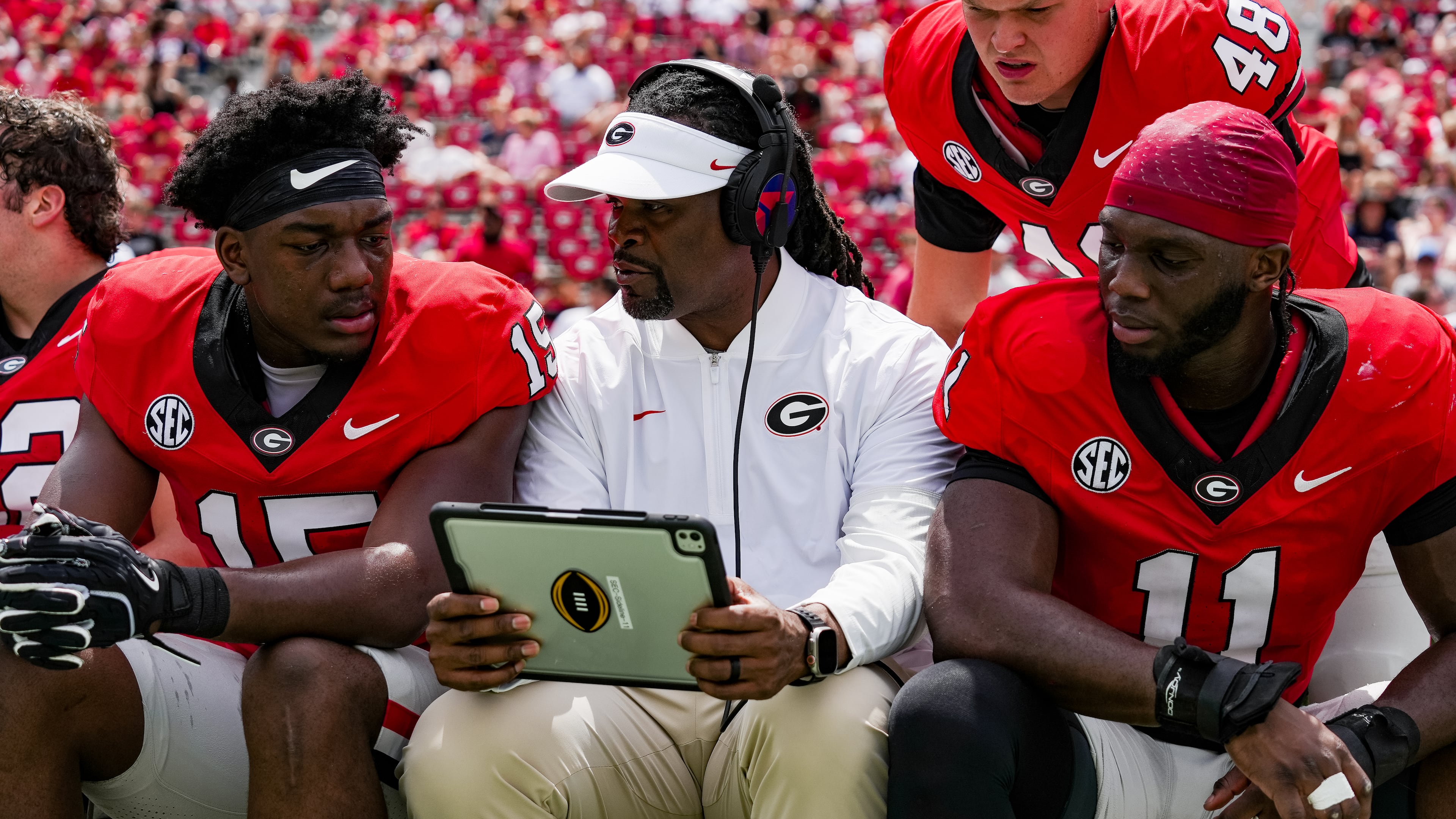 Georgia assistant coach and outside linebackers coach Larry Knight (center) talks with Khamari Brooks (left) and Darren Ikinnagbon (right) at the G-Day spring game on Dooley Field at Sanford Stadium in Athens on Saturday, April 18, 2026. (Tony Walsh/UGAAA)