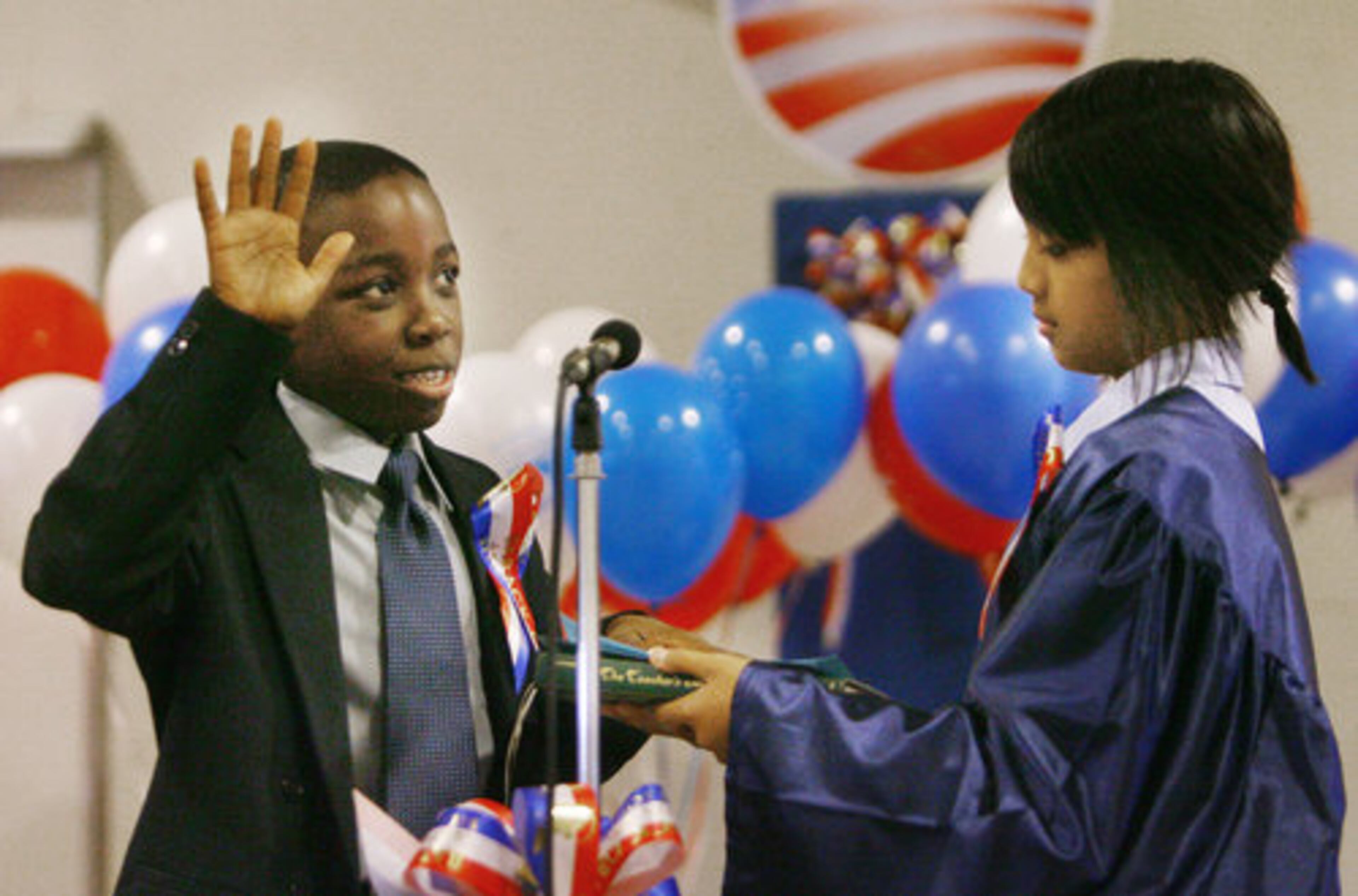 William Cutts (left), standing in for President Barack Obama, holds his hand up as he takes the oath of office from Sabrina Wu (right) standing in for U.S. Supreme Court Chief Justice John Roberts, as students at Chesney Elementary School in Duluth staged their own presidential swearing-in ceremony prior to the real thing Tuesday morning Jan. 20, 2009.