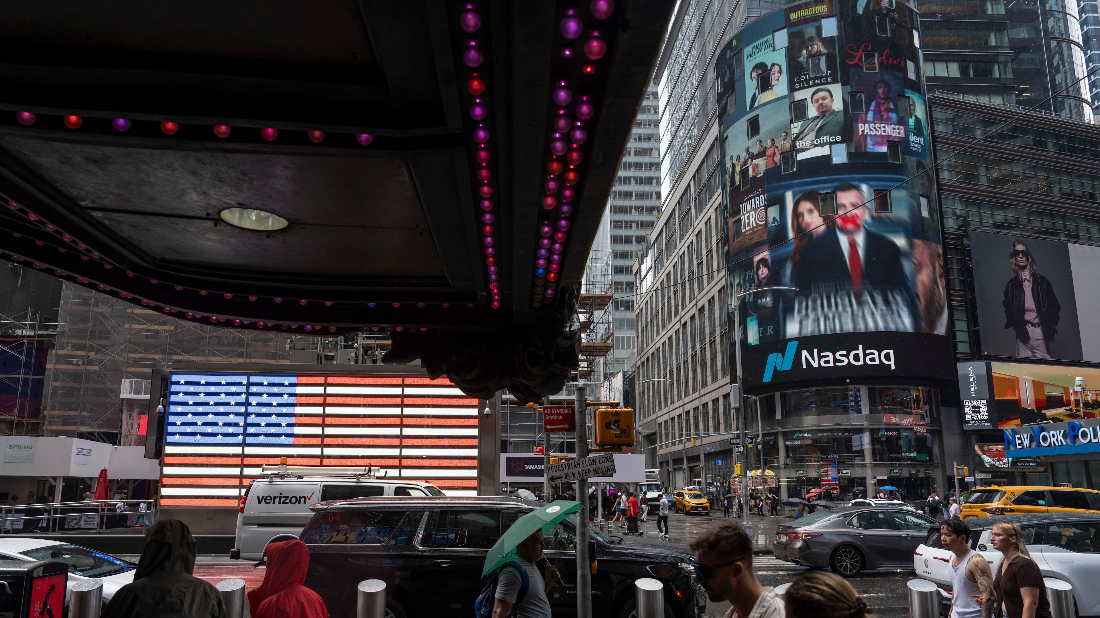 People walk past the Nasdaq MarketSite, Thursday, Aug. 6, 2026, in New York. (AP Photo/Yuki Iwamura)