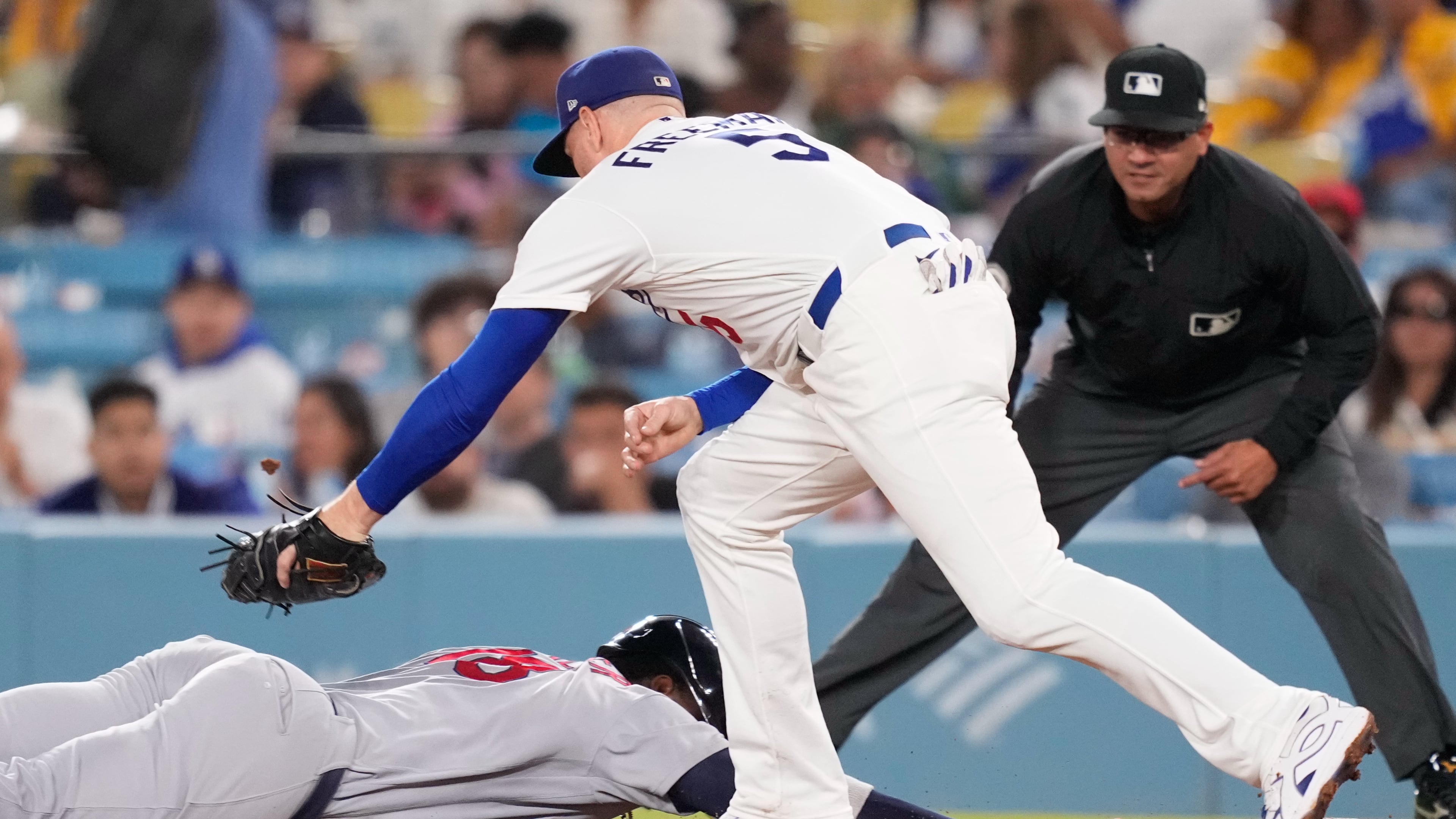 St. Louis Cardinals' Jordan Walker, left, is tagged out at first by Los Angeles Dodgers first baseman Freddie Freeman after being caught off base during the fifth inning of a baseball game Thursday, Sept. 3, 2026, in Los Angeles. (AP Photo/Mark J. Terrill)