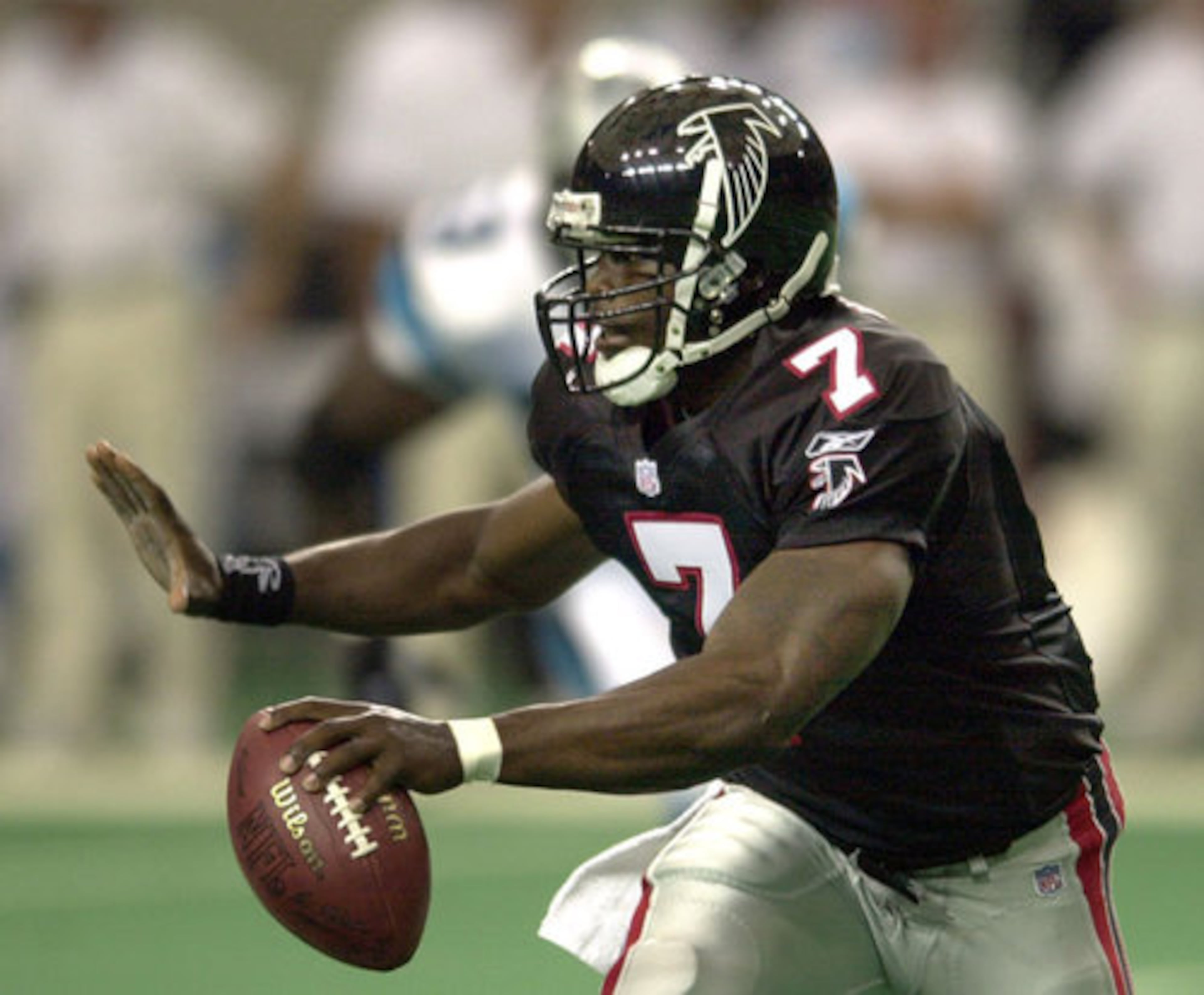010923 ATLANTA:-- Falcons quarterback Michael Vick runs for yardage during 1st half action against the Panthers in the Georgia Dome on Sunday, Sept. 23, 2001. (CURTIS COMPTON/staff)