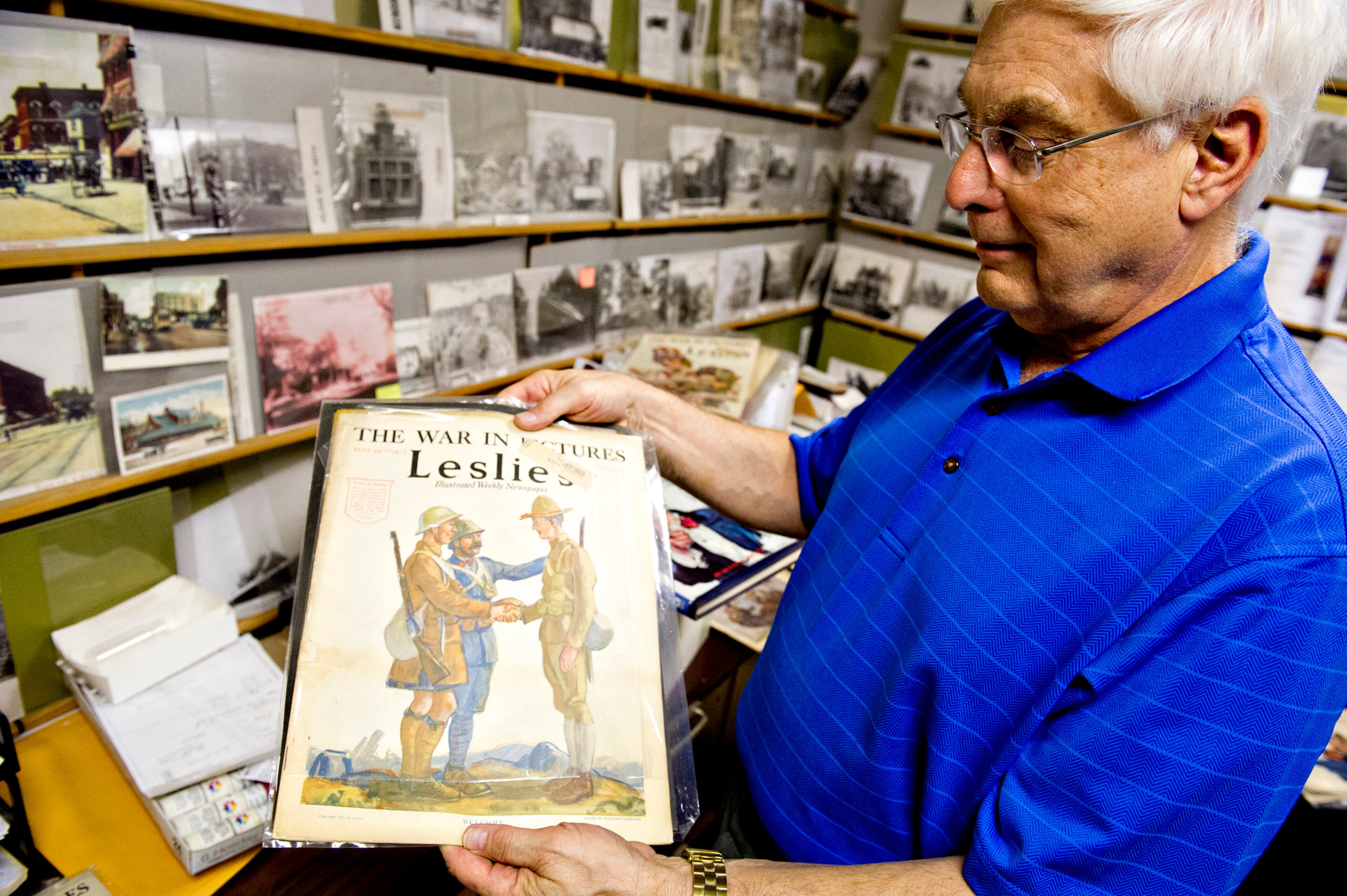 Steve Ehrlich holds up copies of Leslie's Illustrated Weekly Newspaper in his office in Marietta as he explains how the covers were created from 1917-1918 to garner support for World War I on Wednesday, July 2, 2014. Ehlrich, a historian, has close to 70 different issues of the newspaper. JONATHAN PHILLIPS / SPECIAL