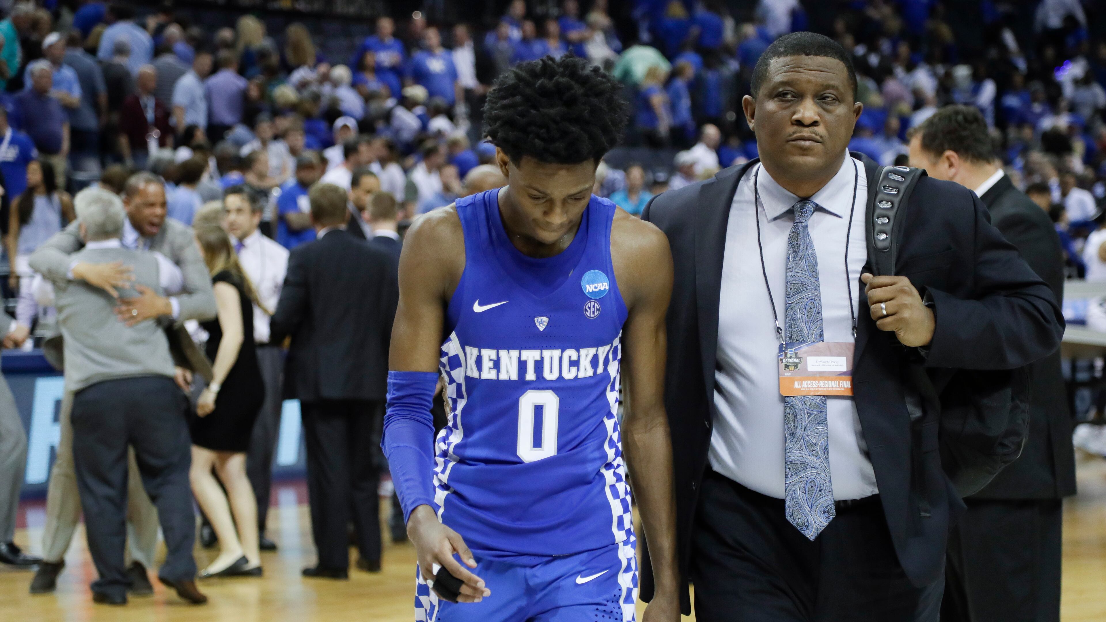 Kentucky guard De'Aaron Fox (0) leaves the court after Kentucky lost to North Carolina 75-73 in the South Regional final game in the NCAA college basketball tournament Sunday, March 26, 2017, in Memphis, Tenn. (AP Photo/Mark Humphrey)