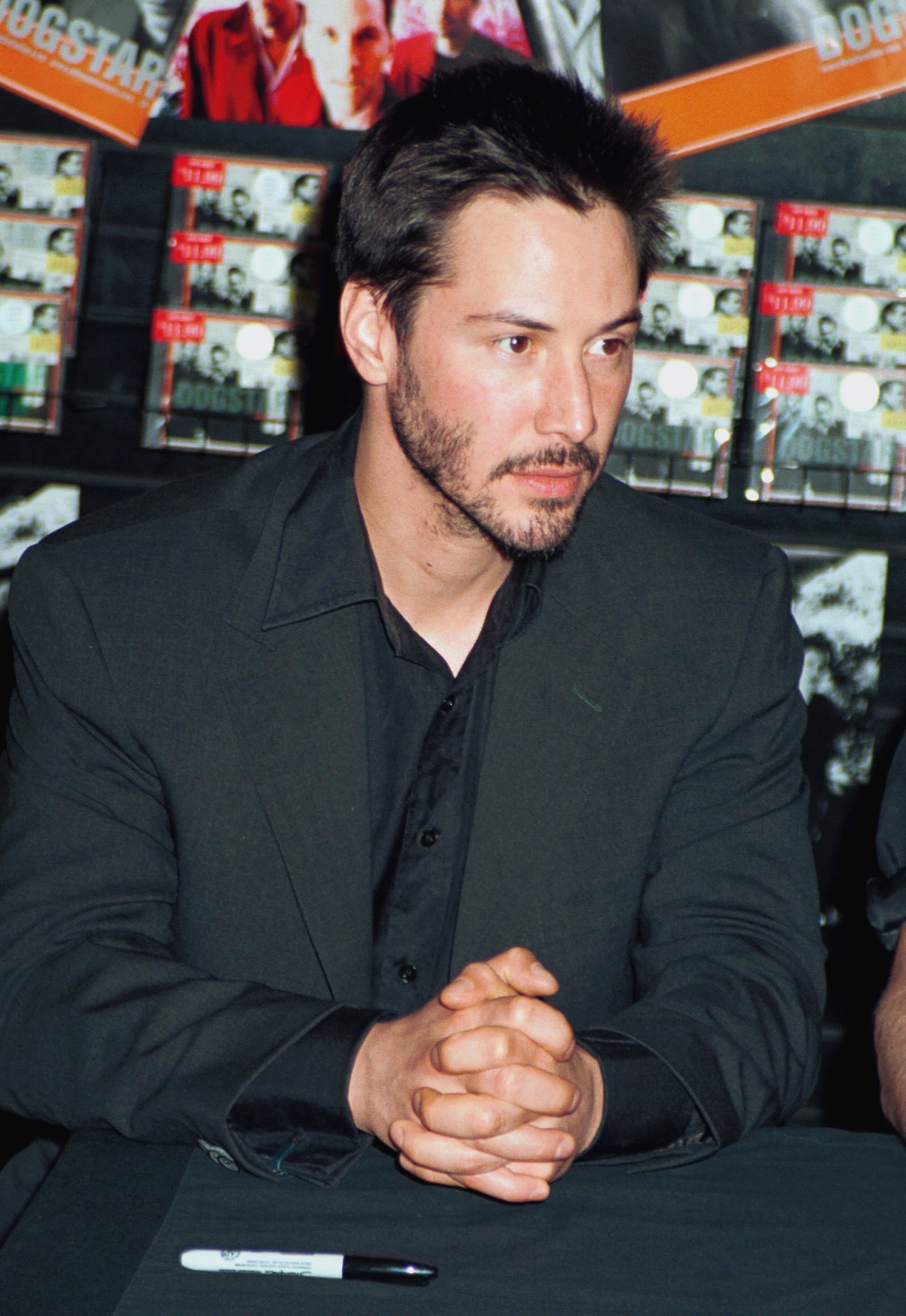 Actor Keanu Reeves poses for photographers July 11, 2000, at an in-store signing for his band Dogstar's new CD at Coconuts Music Stores in New York City.