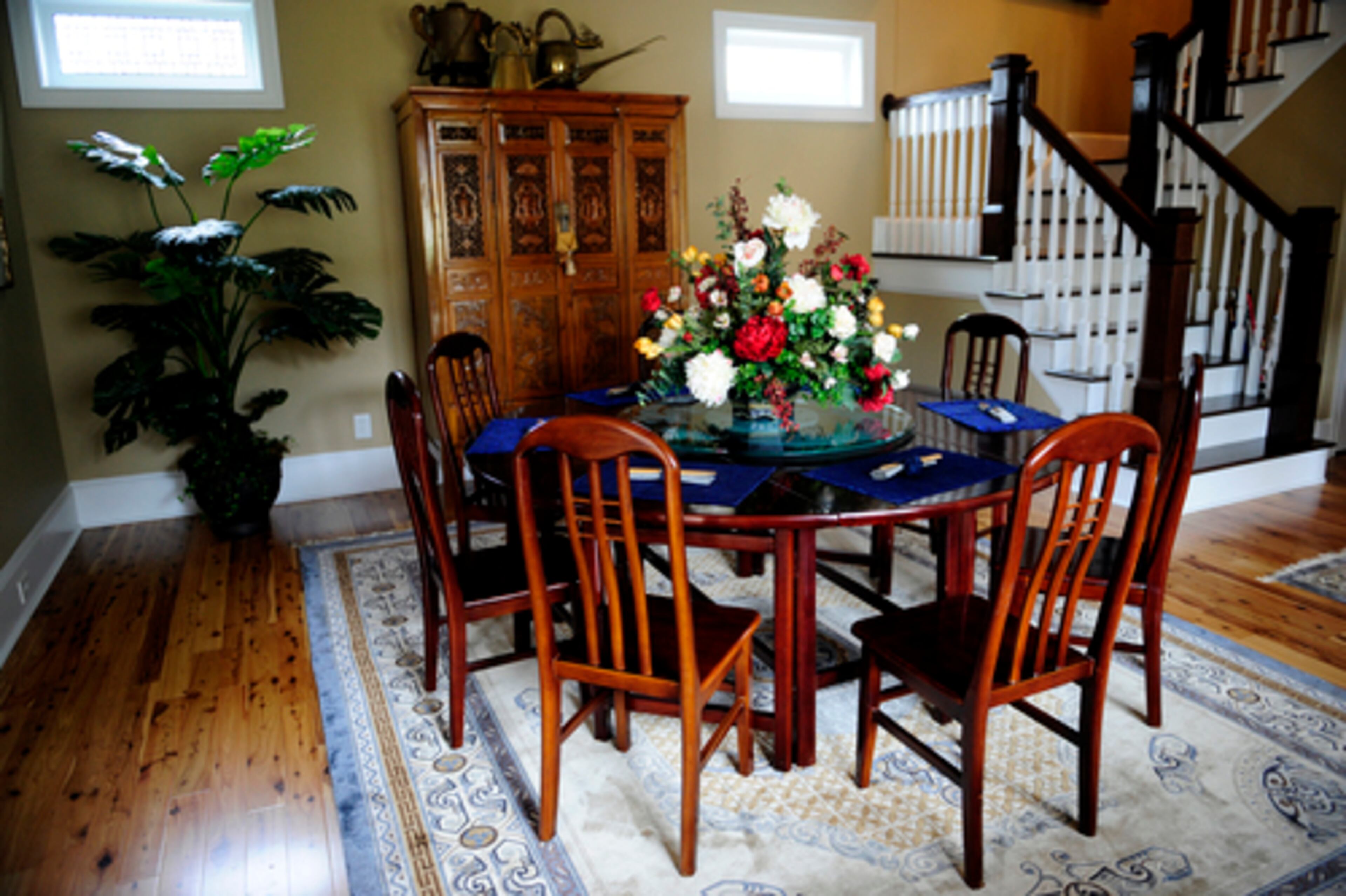 Much of the furniture in the home was commissioned or purchased in China. The seats of the dining room chairs are made from old wood floors. Buddy Neel wanted a round table to promote interaction, so he had this one made.