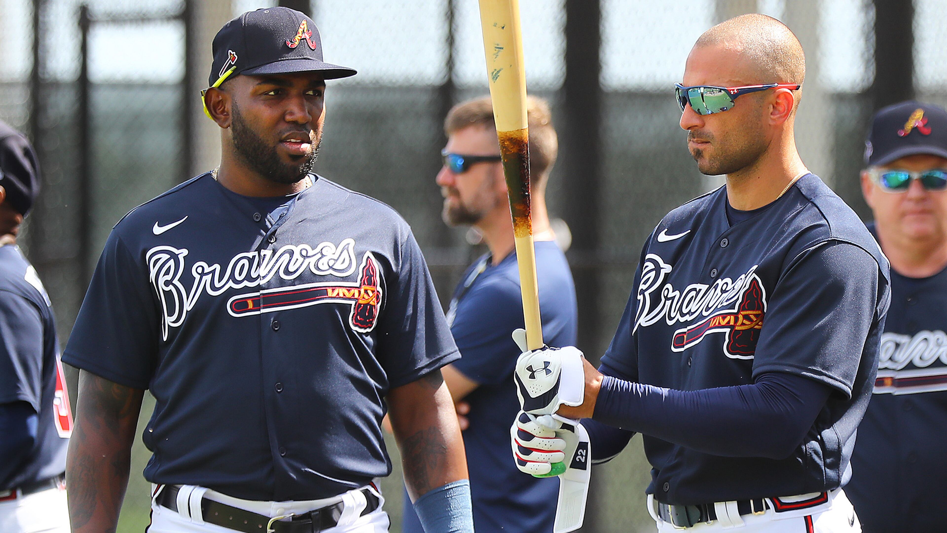Braves outfielder Nick Markakis (right) checks out new teammate Marcell Ozuna's bat during batting practice Tuesday, Feb. 18, 2020, at CoolToday Park in North Port, Fla.