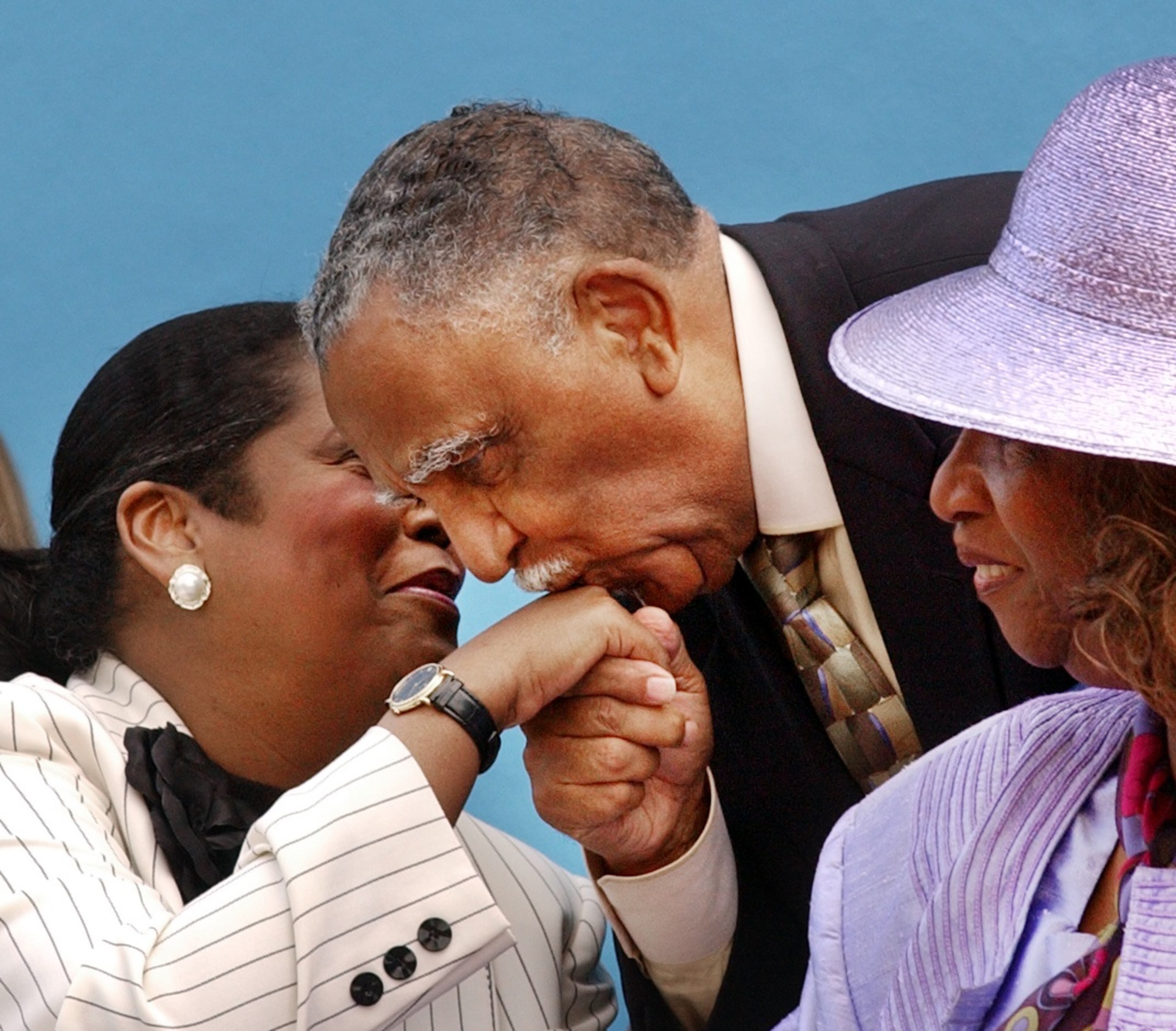 Rev. Joseph E. Lowery kisses the hand of Ingrid Saunders Jones before ceremonies for the unveiling of the International Civil Rights Walk of Fame at the Martin Luther King Jr. National Historic site in Atlanta in 2004. (JOEY IVANSCO/AJC staff photo).