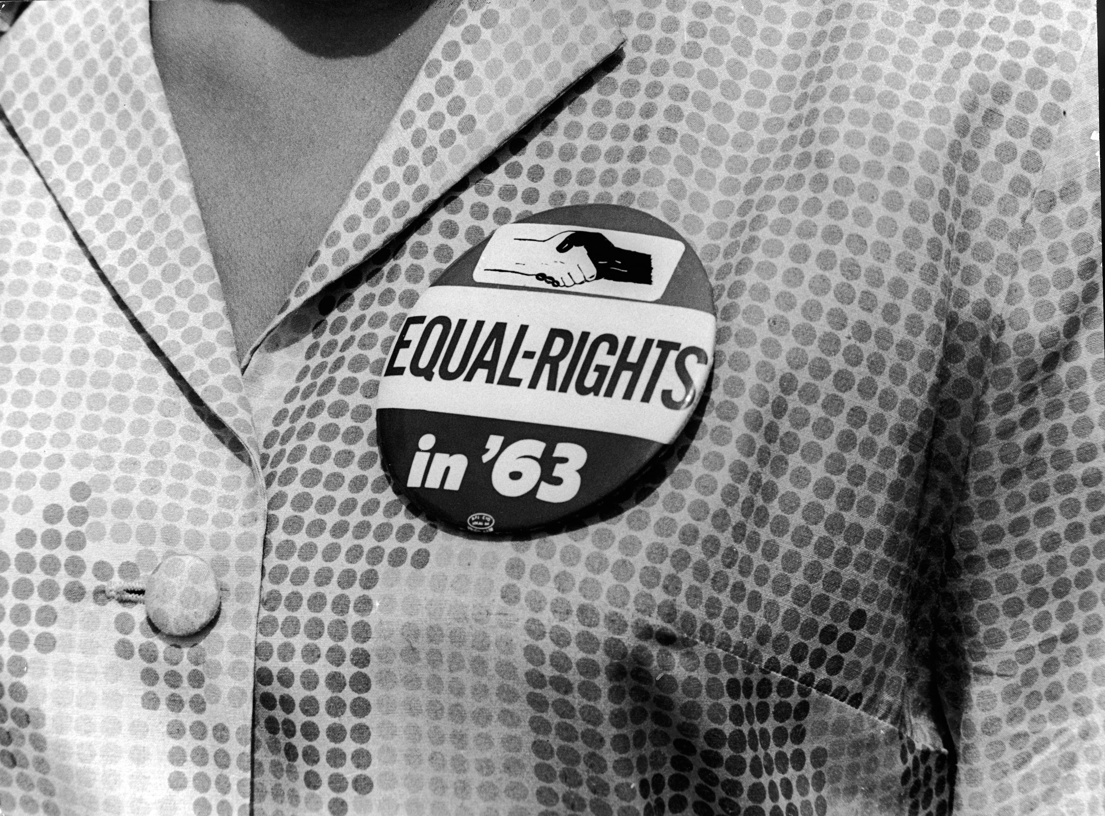 A close-up of a civil rights protest button being worn by a female demonstrator at the March on Washington, Washington, DC, August 28, 1963. (Photo by Express Newspapers/Getty Images)