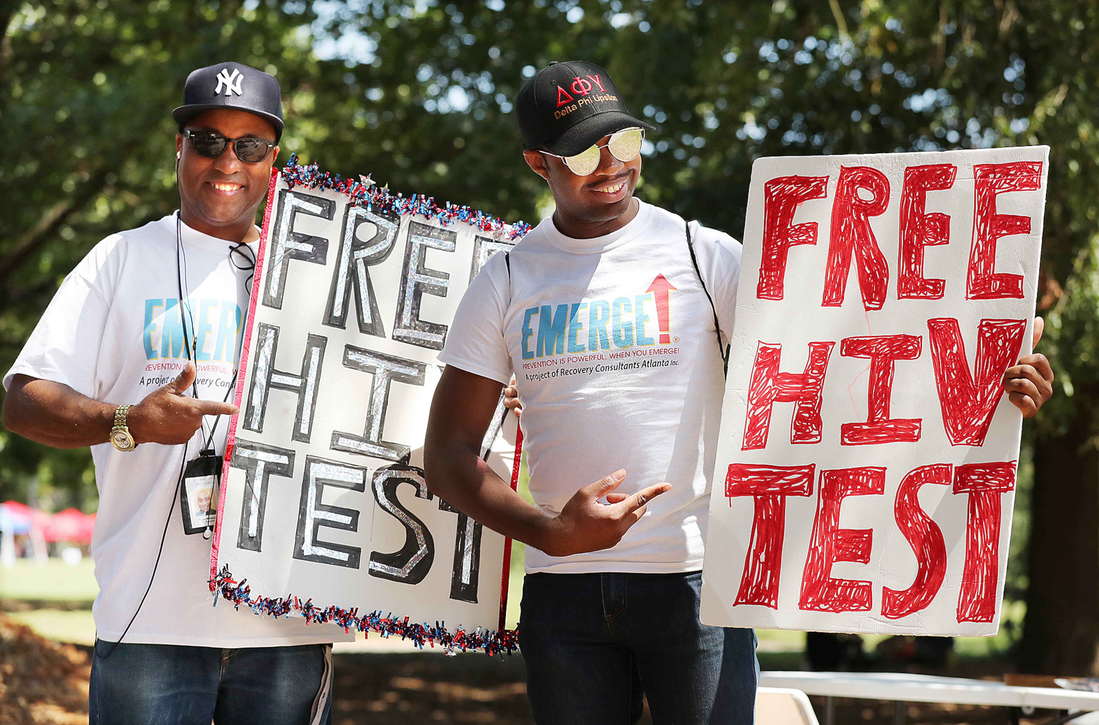 Reggie McKenzie (left) and Jamie Allen encourage attendees to get a free AIDS test during the Pure Heat Community Festival, part of Black Gay Pride weekend, at Piedmont Park on Sunday, Sept. 4, 2016, in Atlanta. Curtis Compton /ccompton@ajc.com