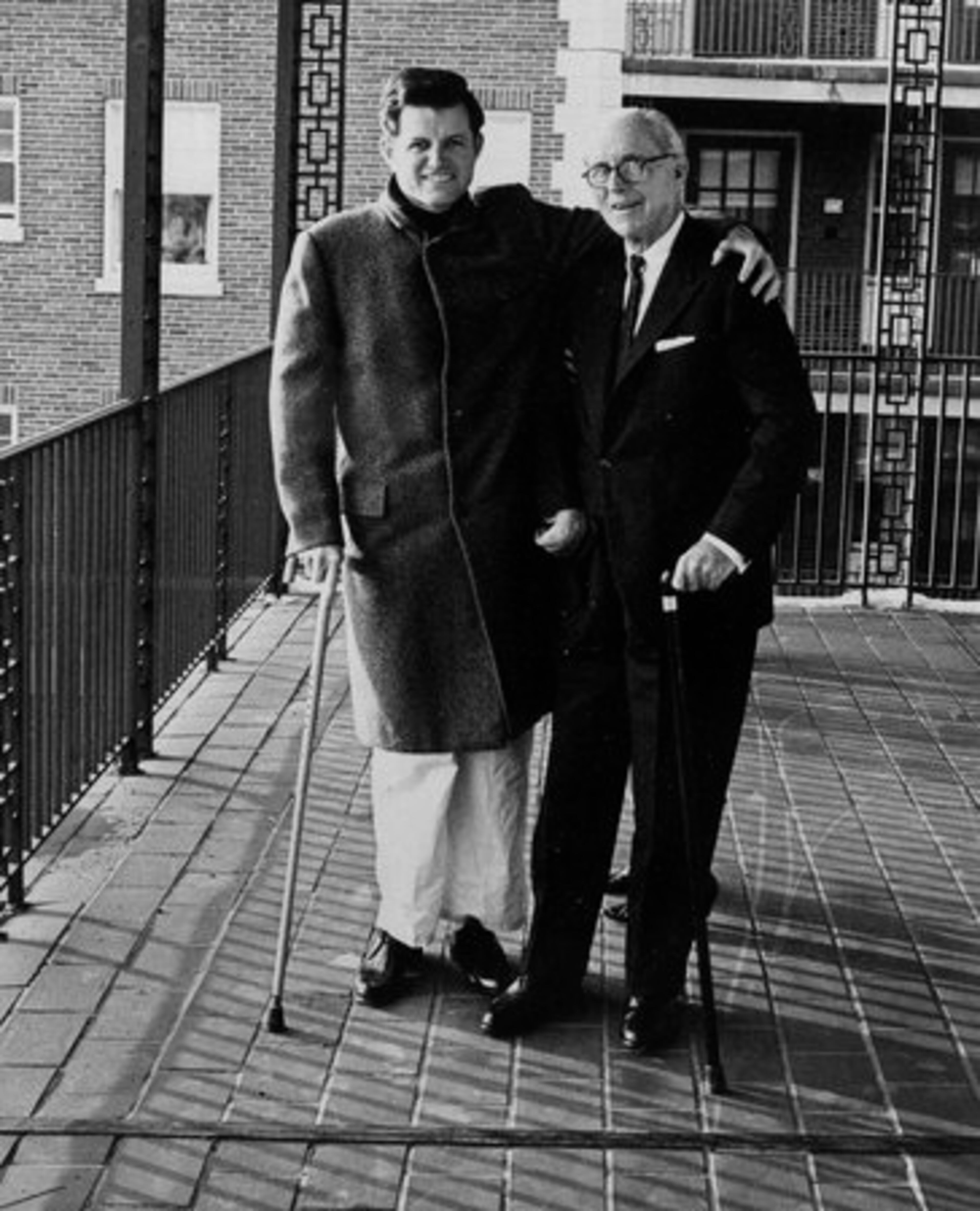 Sen. Edward M. Kennedy, left, takes a stroll with his father former ambassador Joseph P. Kennedy on an open porch at New England Baptist Hospital in Boston, Dec. 8, 1964, where the senator is recuperating from the broken back he suffered in a plane crash. Sen. Ted Kennedy has died after battling a brain tumor his family announced early Wednesday Aug. 26, 2009.