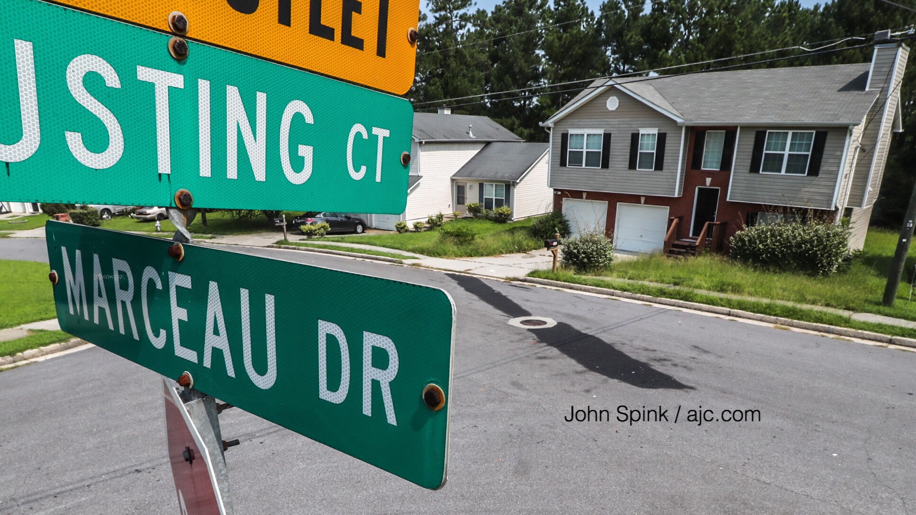 The GBI is investigating an officer-involved shooting in the 1800 block of Marceau Drive near Conley, a spokeswoman said. The oil slick marks the spot where a woman hit a police officer and pinned him against a patrol car.