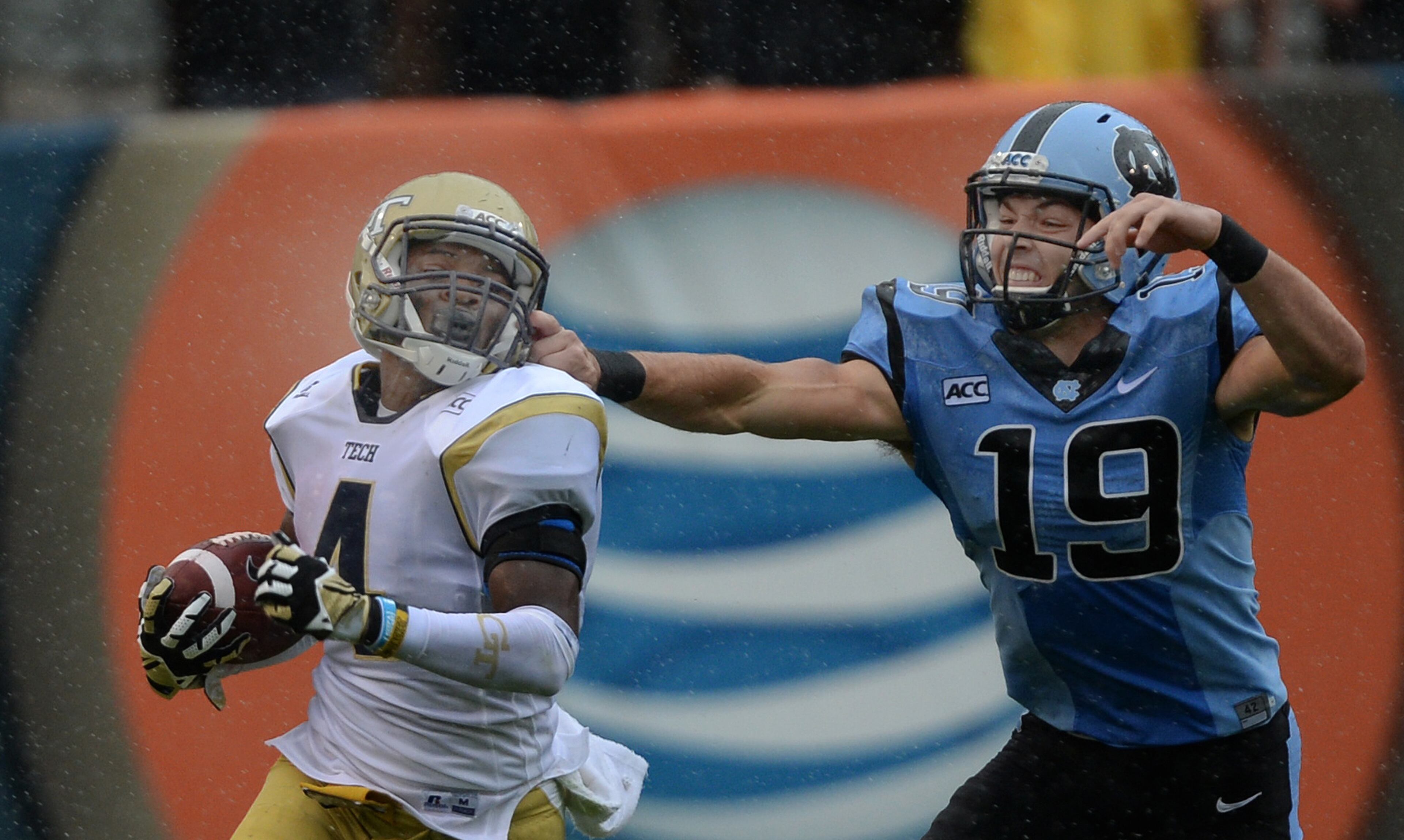Georgia Tech's Jamal Golden (4) gets his face mask pulled by North Carolina's Nick Weiler (19) in the rain inside Bobby Dodd Stadium.