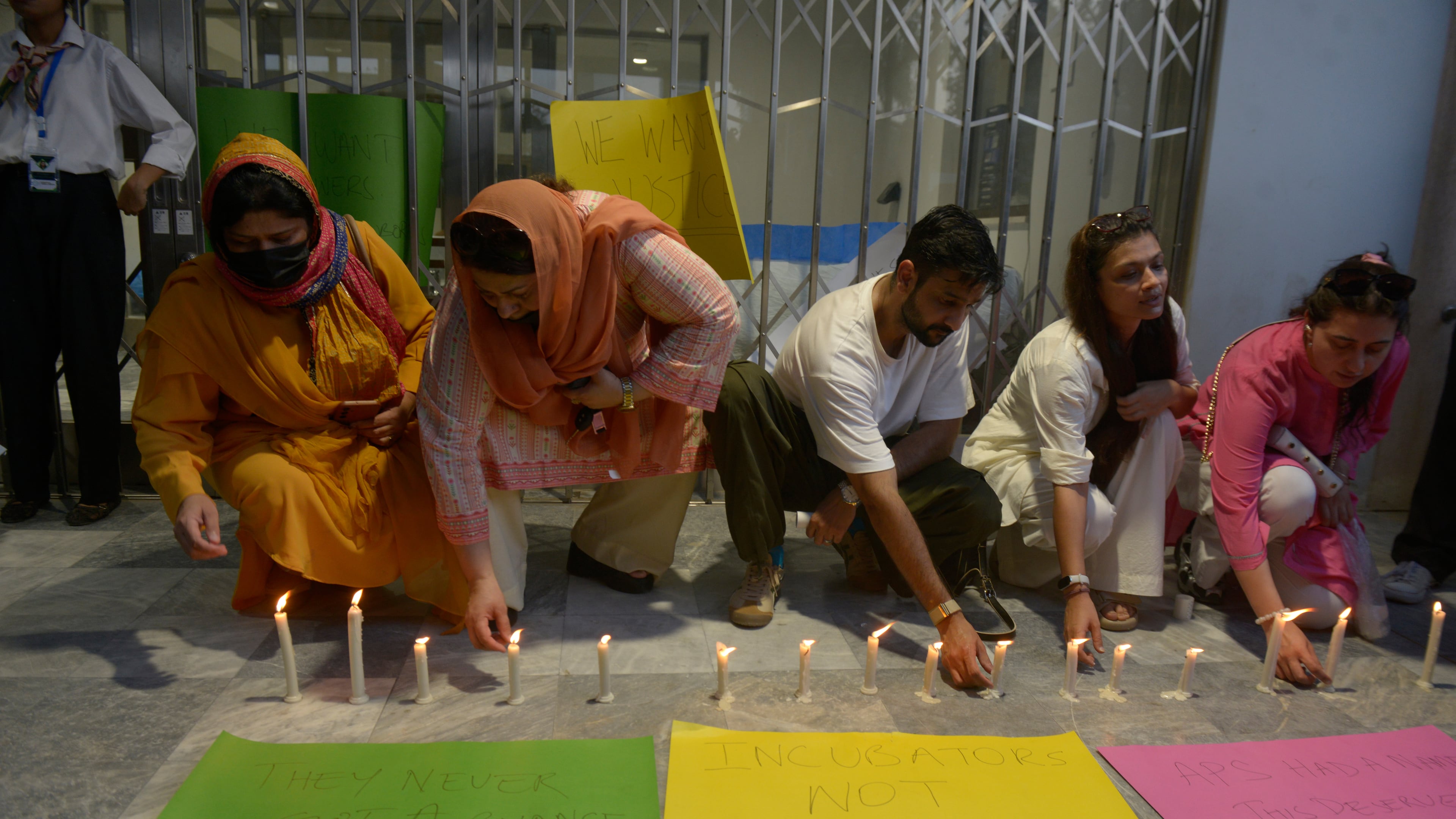 People light candles in the memory of the newborn victims outside the Mother and Child Health ward at the Pakistan Institute of Medical Sciences, in Islamabad, Pakistan, Thursday, Aug. 27, 2026. (AP Photo/M.A. Sheik)