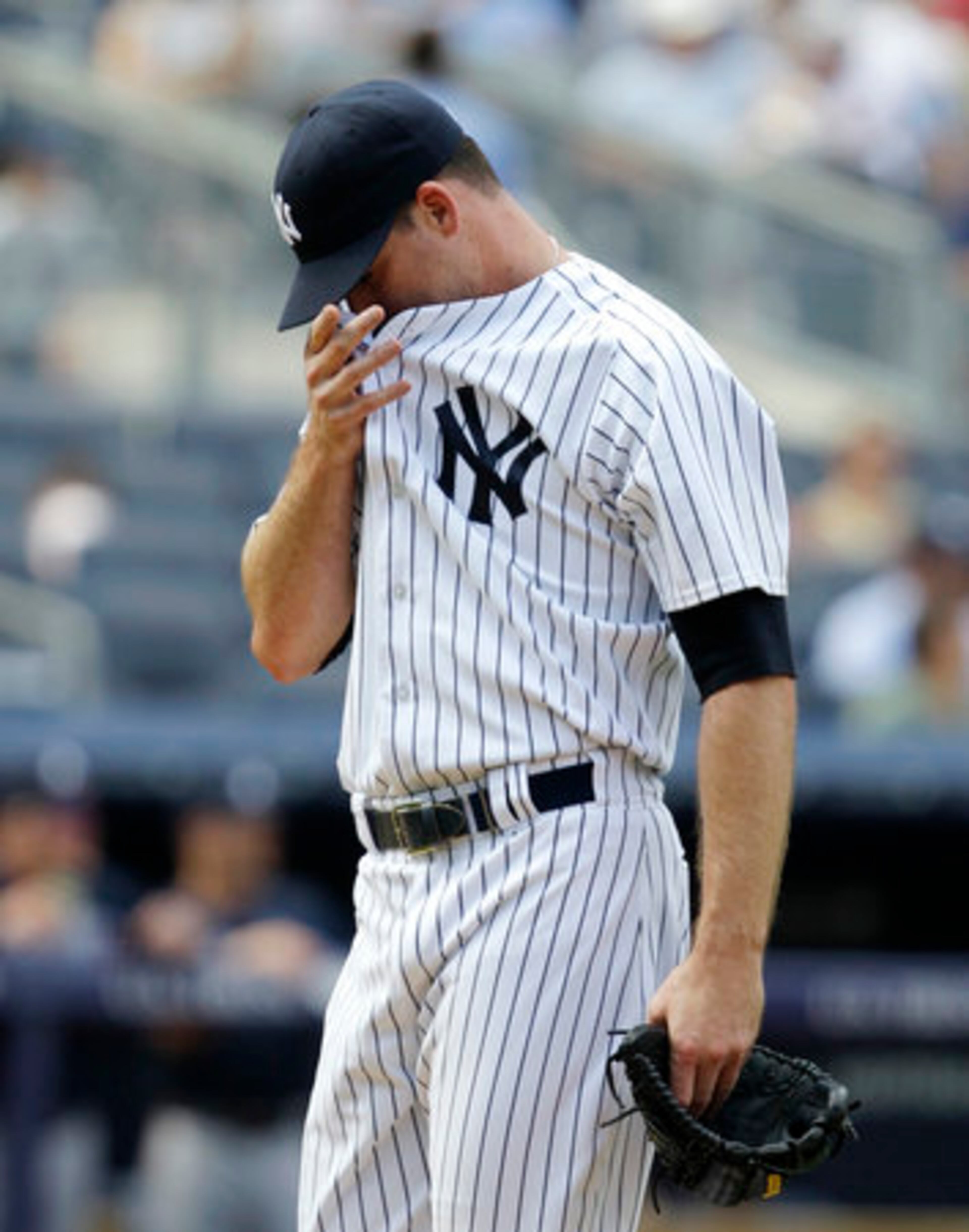 New York Yankees relief pitcher Boone Logan leaves the mound after giving up an eighth-inning, two-run home run to Atlanta Braves' Jason Heyward during a baseball game at Yankee Stadium in New York, Wednesday, June 20, 2012.