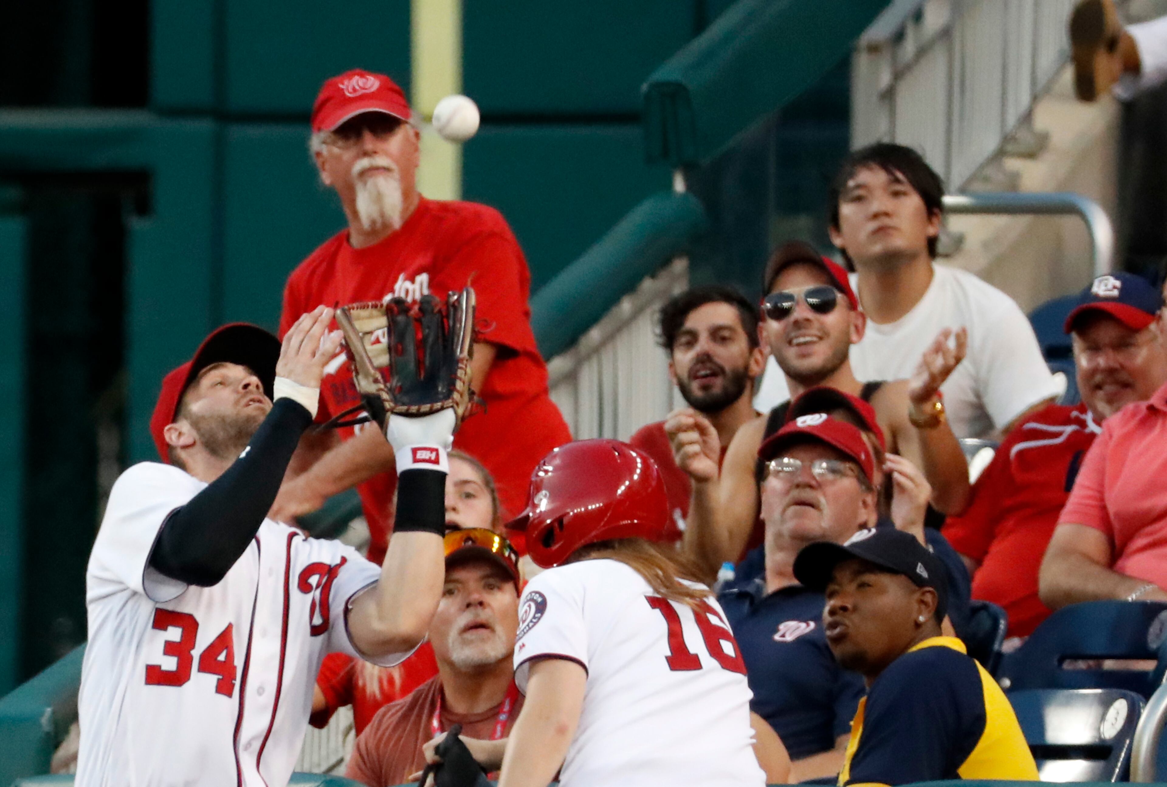 Washington Nationals right fielder Bryce Harper (34) catches a foul ball for an out on Atlanta Braves' Nick Markakis during the first inning of a baseball game at Nationals Park, Tuesday, Sept. 6, 2016, in Washington. (AP Photo/Alex Brandon)