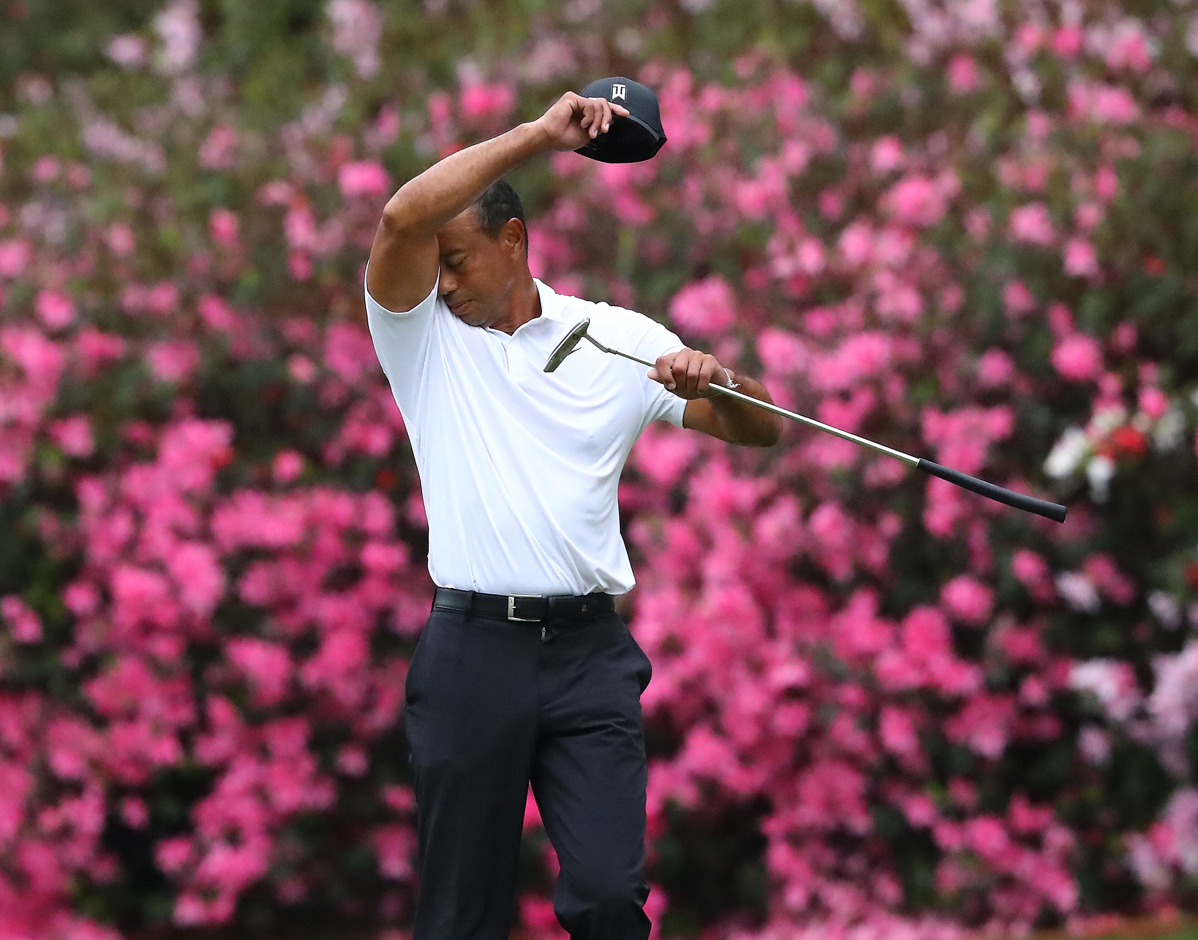 Tiger Woods wipes his face taking a momentary break on the 13th green during his practice round for the Masters at Augusta National Golf Club on Wednesday, April 6, 2022, in Augusta. “Curtis Compton / Curtis.Compton@ajc.com”