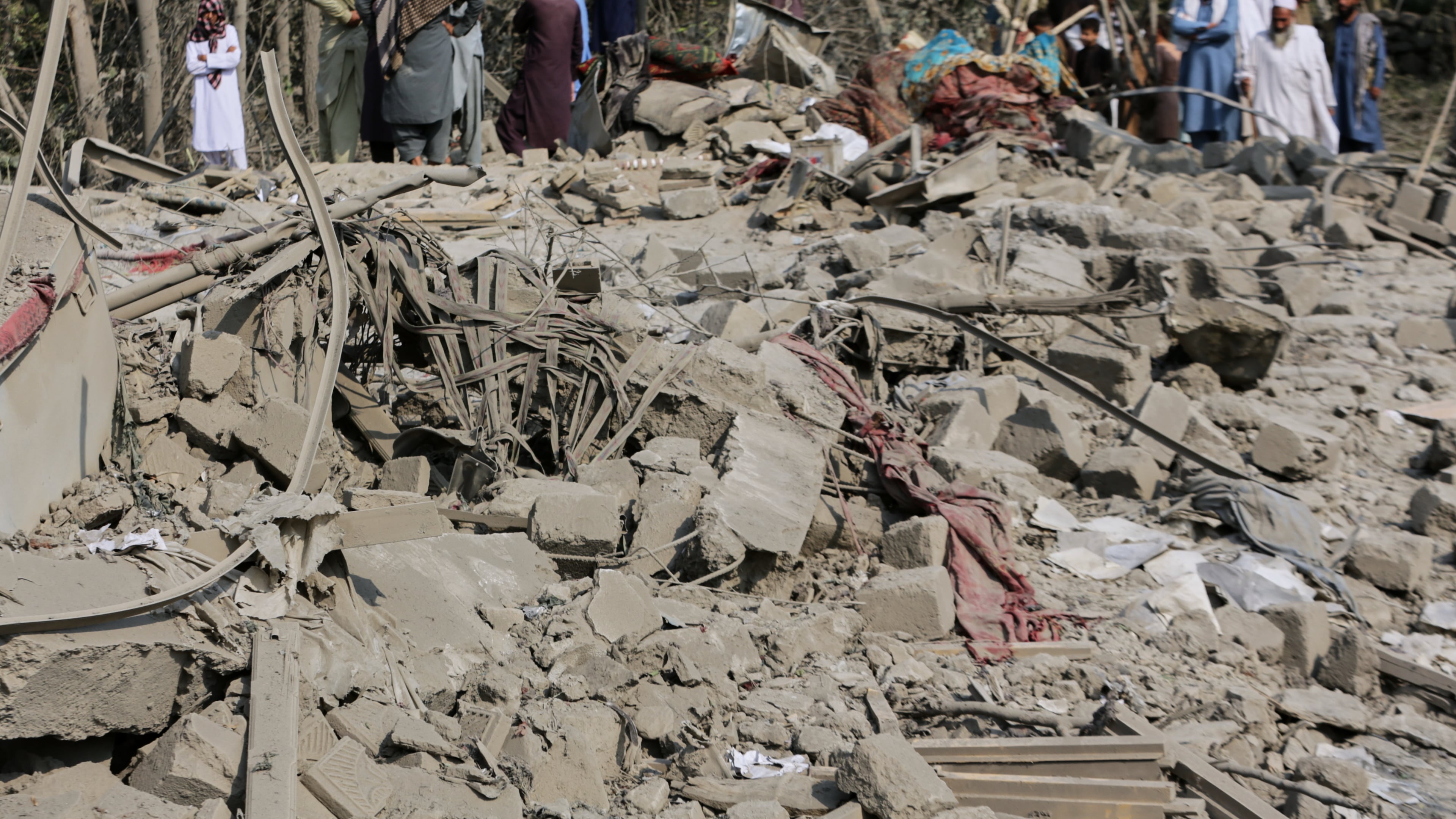 Residents inspect the rubble of a house destroyed in a strike in Patan village, Kunar province, eastern Afghanistan, Monday, Sept. 21, 2026. (AP Photo/Shafiullah Kakar)