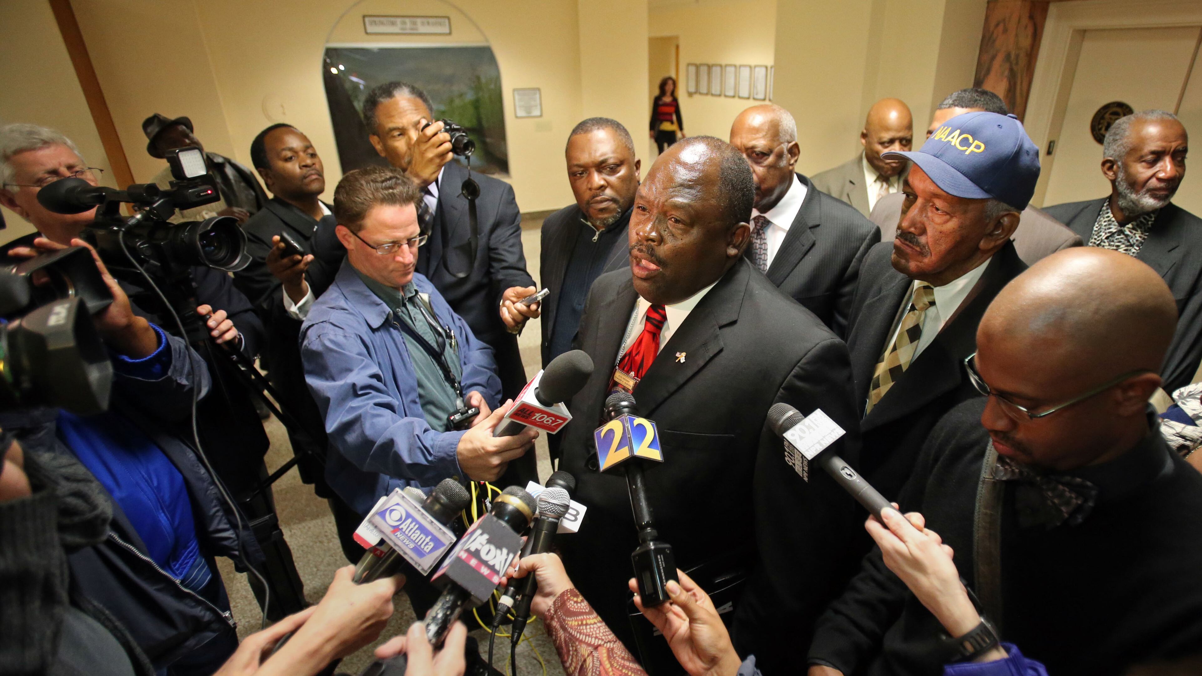 Edward DuBose, President of the Georgia State Conference NAACP, center, talks with members of the media following a meeting with Gov. Nathan Deal at the Capitol Monday afternoon in Atlanta, Ga., March 11, 2013. The meeting, which was closed to the public, was about the removal of six DeKalb school board members earlier this month. JASON GETZ / JGETZ@AJC.COM