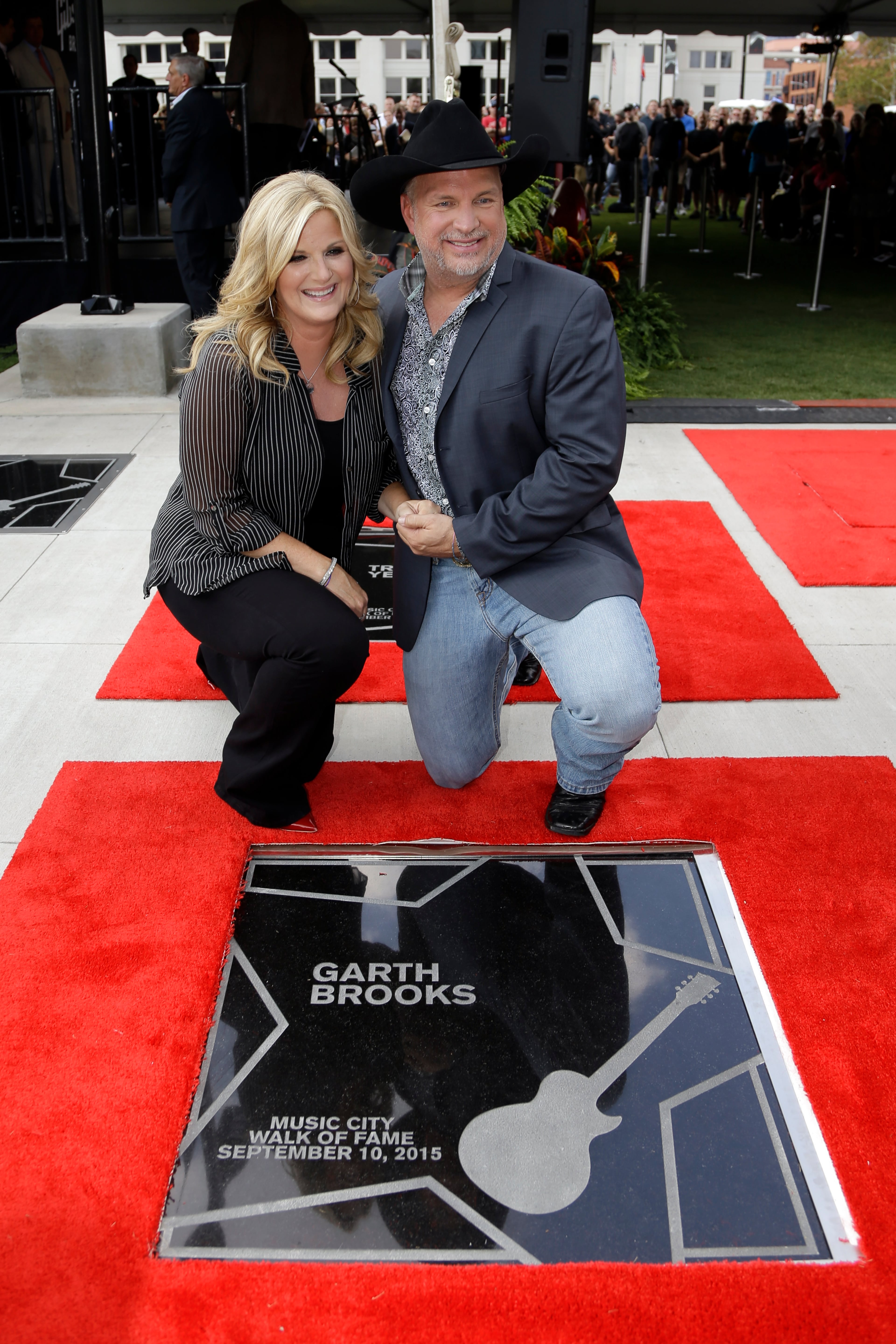 Garth Brooks and Trisha Yearwood pose by Brooks' star on the Music City Walk of Fame on Thursday, Sept. 10, 2015, in Nashville, Tenn. (AP Photo/Mark Humphrey)