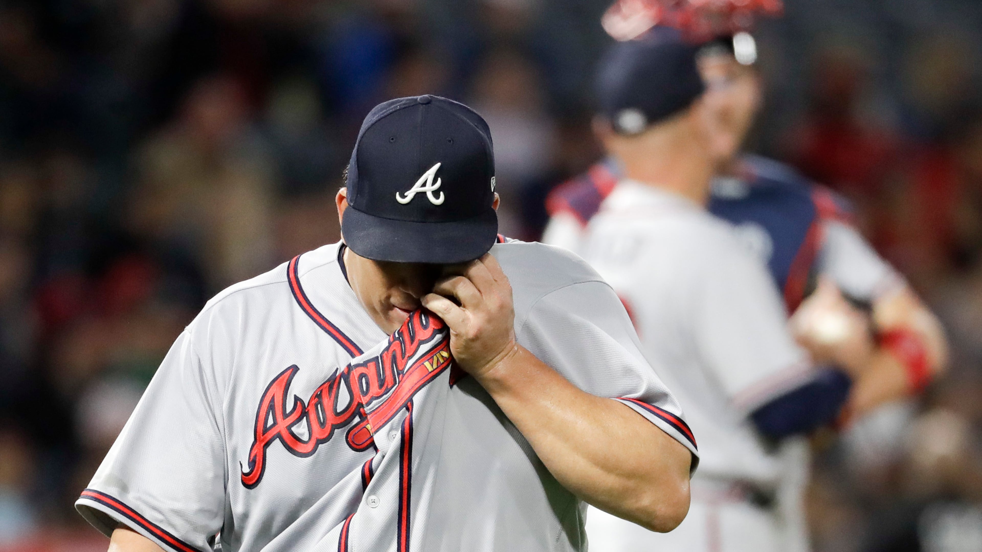 Braves starting pitcher Bartolo Colon wipes his face as he leaves the field after giving up ninth runs to the Los Angeles Angels during the third inning. (AP Photo/Chris Carlson)