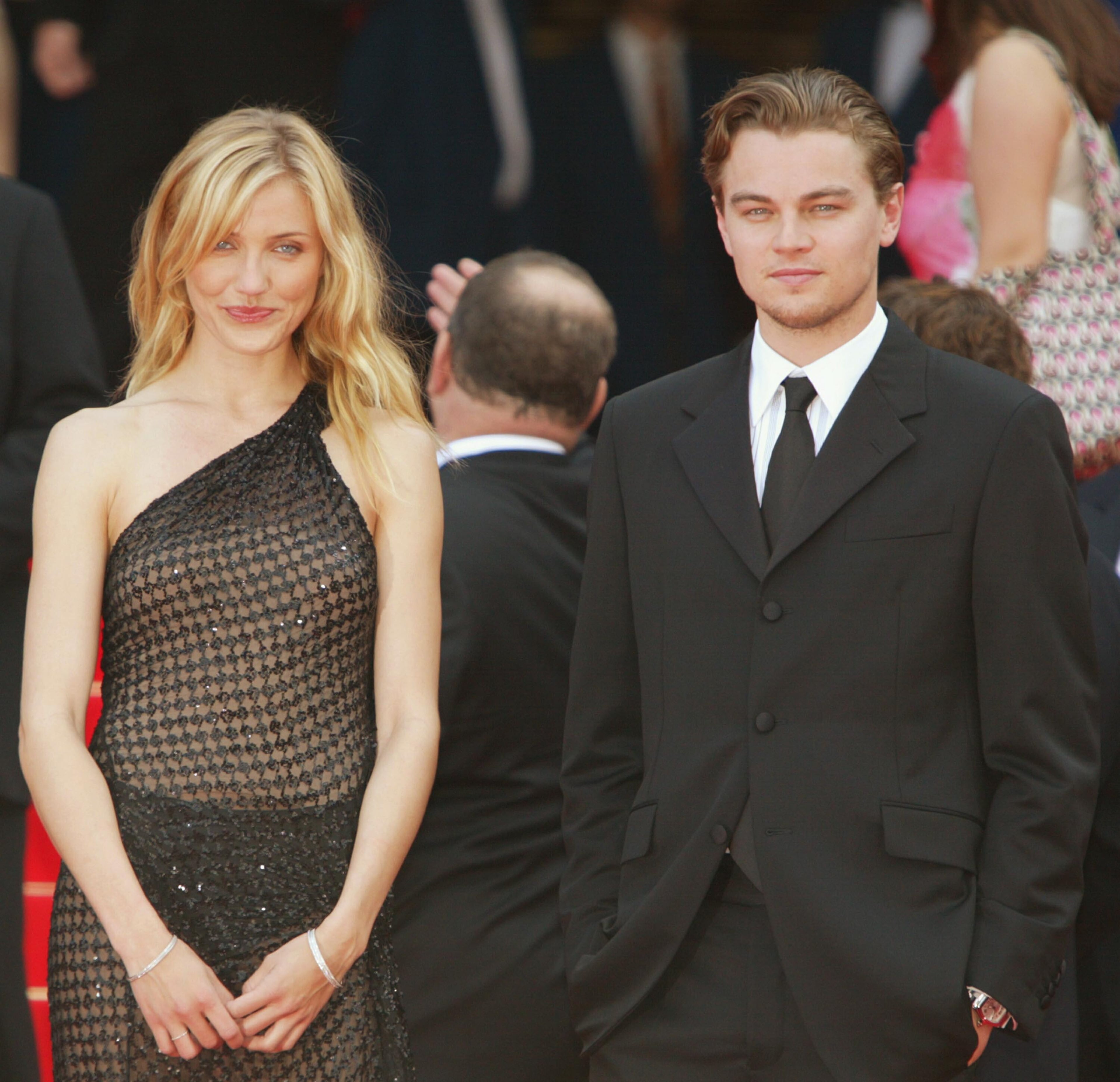 Actress Cameron Diaz (left) and actor Leonardo DiCaprio (right) pose for photographers during the red carpet arrivals for the official screening of director Martin Scorsese's film "Gangs of New York" at the 55th International Cannes Film Festival on May 20, 2002, in Cannes, France.