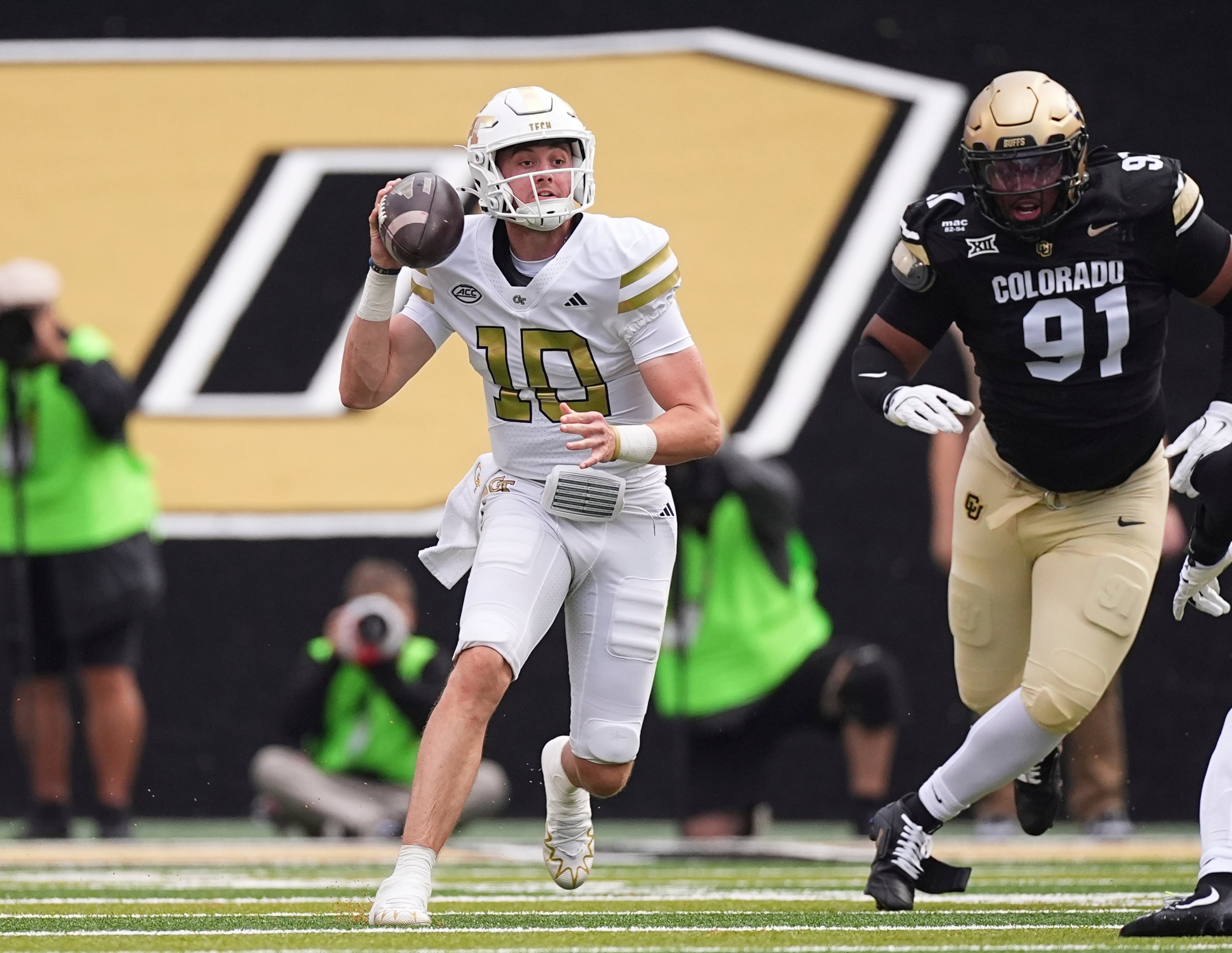 Georgia Tech quarterback Haynes King (left) looks to pass the ball as Colorado defensive end Brandon Davis-Swain pursues during the first half on Friday, Aug. 29, 2025, in Boulder, Colo. (David Zalubowski/AP)