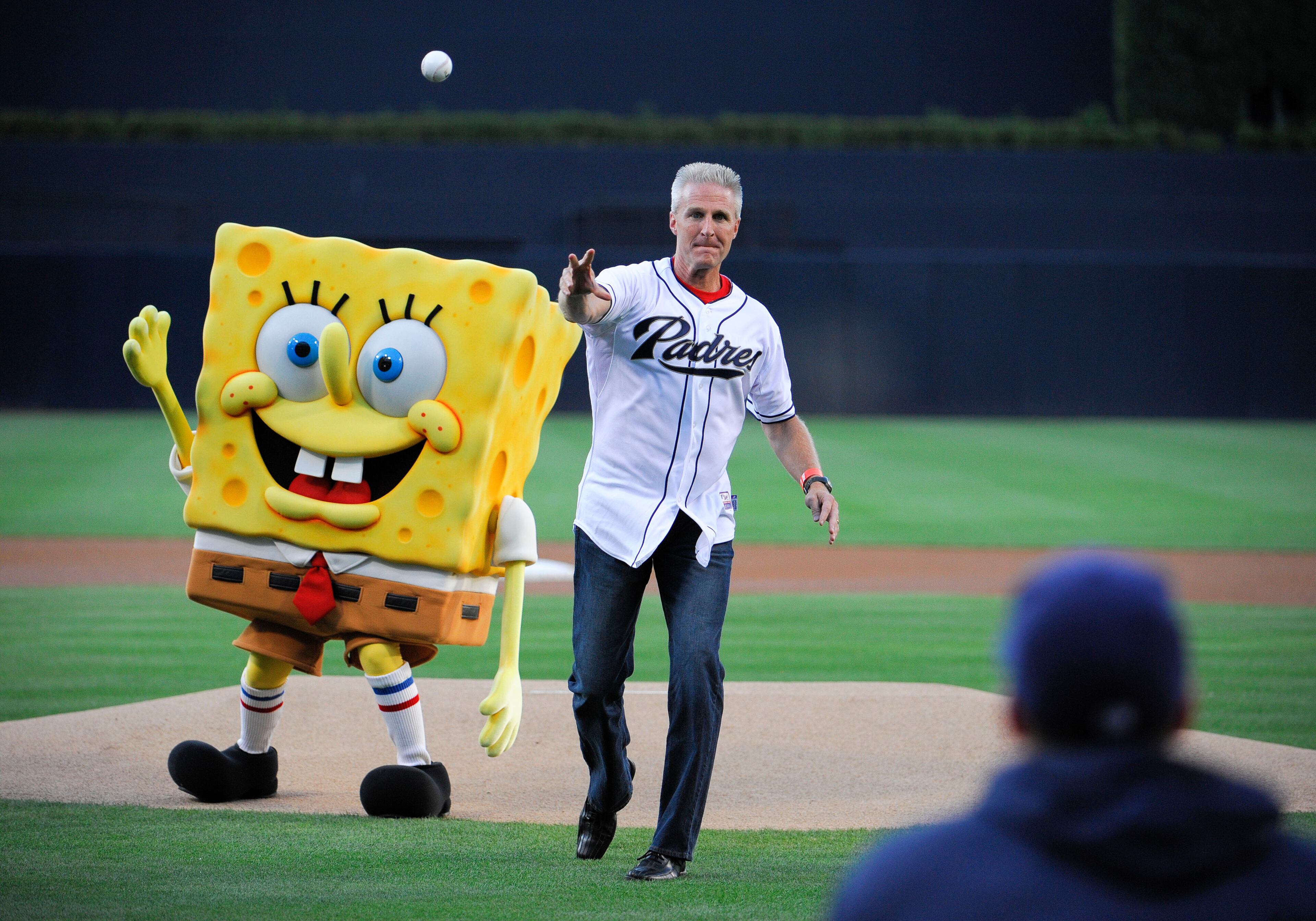 Jack Hollis and Spongebob throw out the first pitch before a baseball game between the San Diego Padres and San Francisco Giants at Petco Park on July 13, 2013 in San Diego, California.