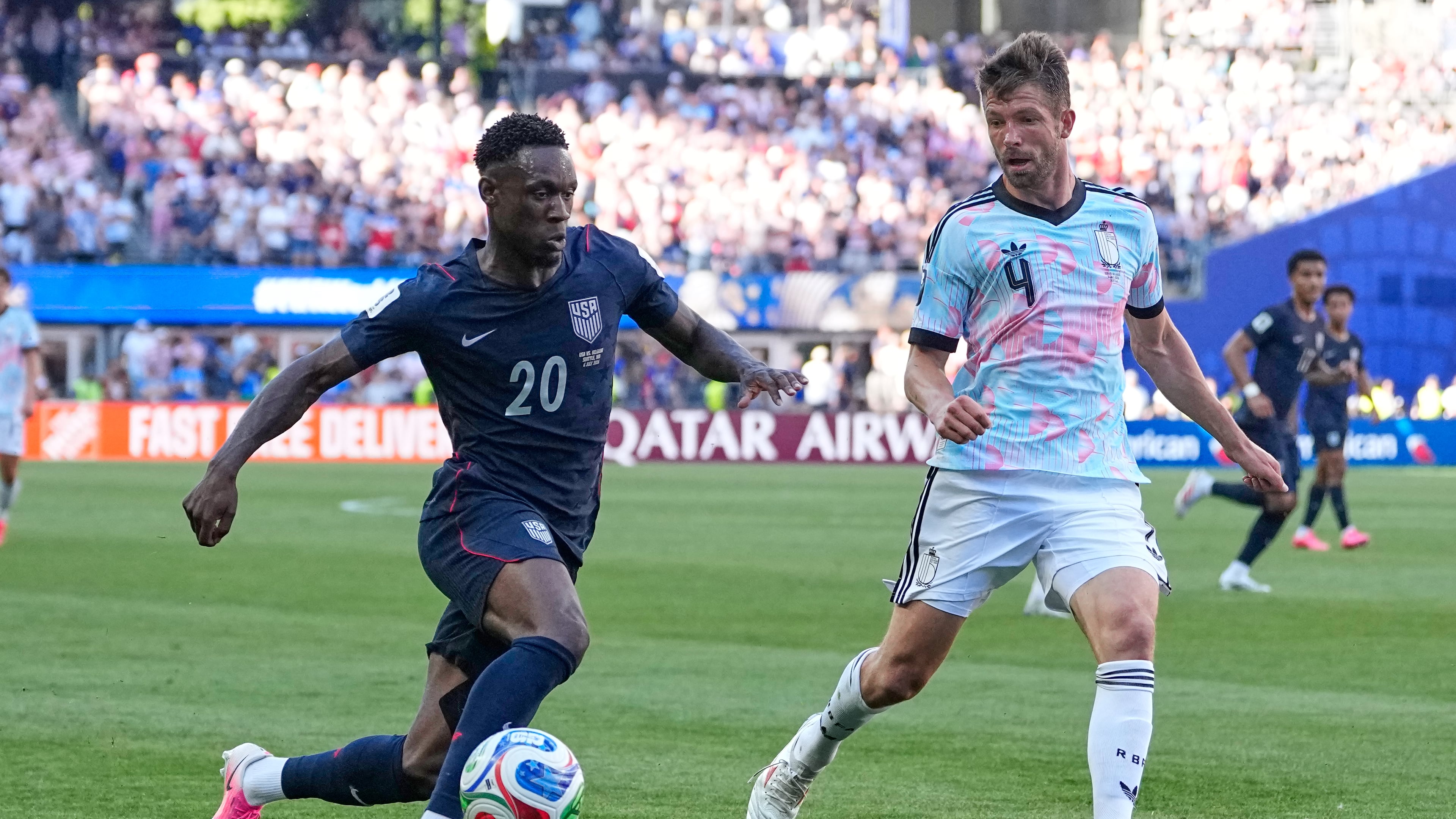 United States' Folarin Balogun (20) and Belgium's Brandon Mechele (4) battle for the ball during the World Cup round of 16 soccer match between the United States and Belgium in Seattle, Monday, July 6, 2026. (AP Photo/Lindsey Wasson)