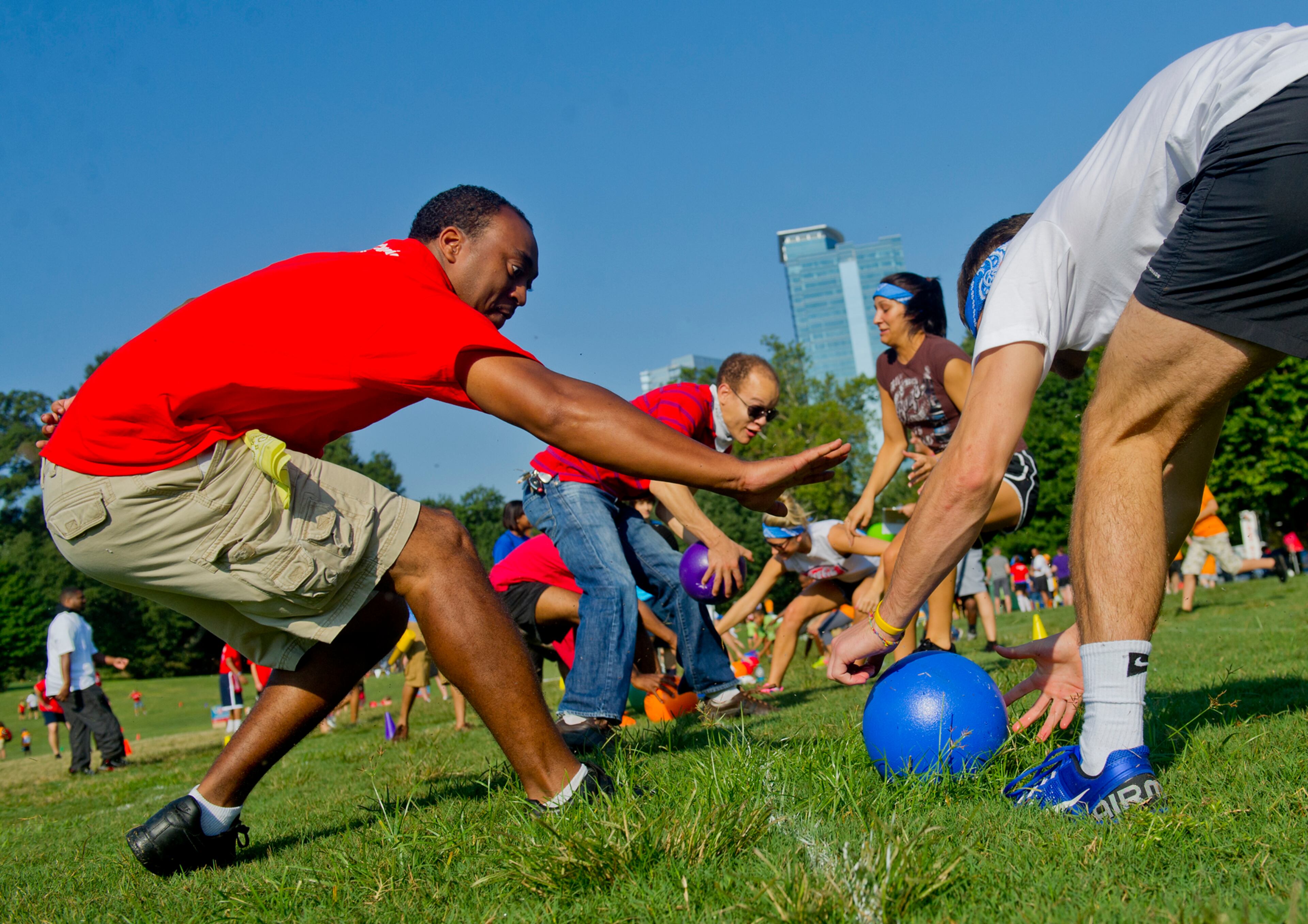Eric Clark (left) tries to beat Zack Wilcox to the ball at the start of a game of dodgeball during the Boys & Girls Clubs of America's Day for Kids at Piedmont Park in Atlanta on Saturday, September 7, 2013. Day for Kids is a national initiative to raise awareness for critical issues facing young men and women. With more than a decade of tradition, Day for Kids invites adults to act like kids again by participating in field day events such as relay races, dodge ball, tug of war and lots of other activities. JONATHAN PHILLIPS / SPECIAL