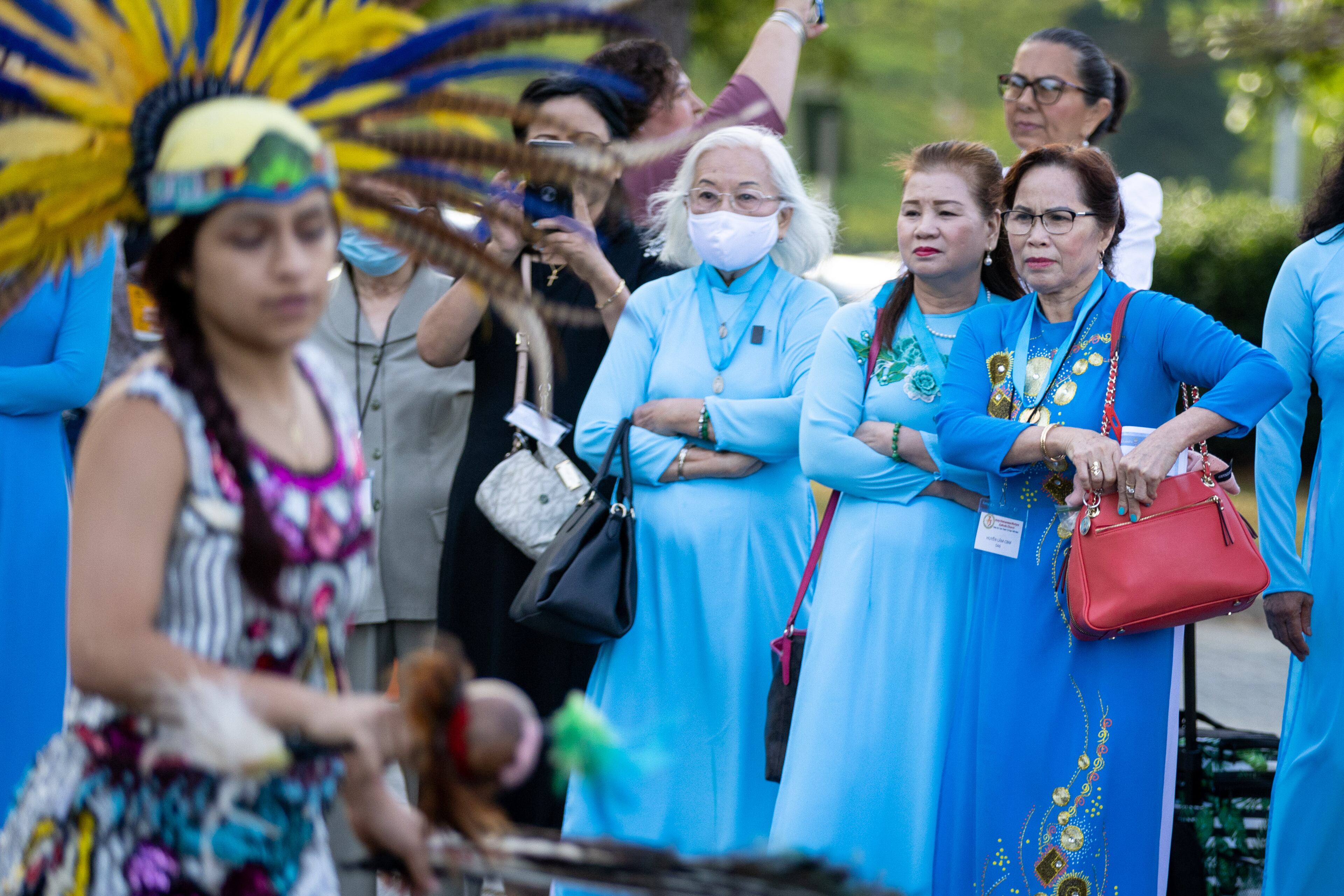People watch An Aztec dance group perform before the start of the 25th Eucharistic Congress at the Georgia International Convention Center in College Park on June 18, 2022 (Steve Schaefer / steve.schaefer@ajc.com)