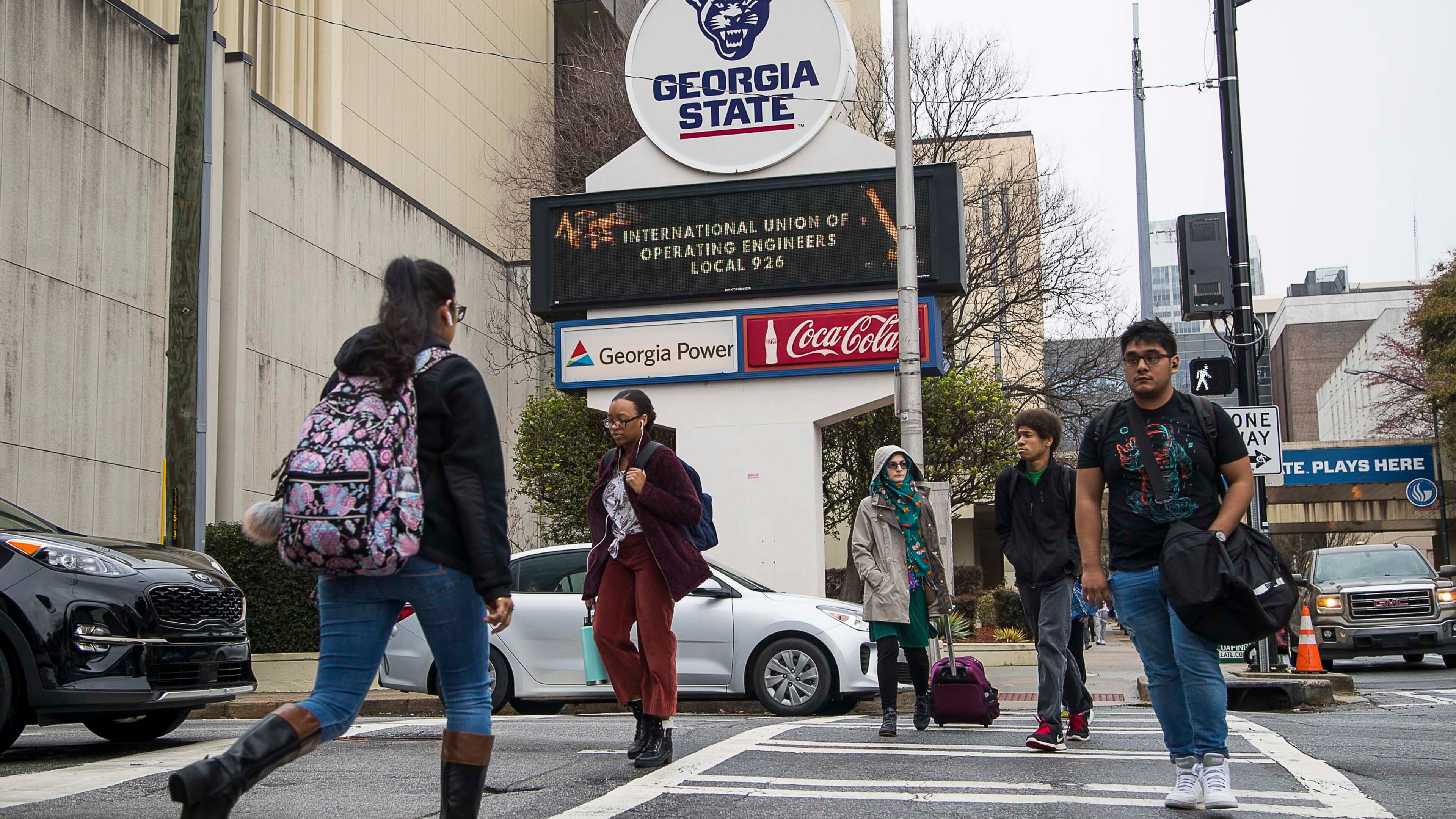 03/10/2020 -- Atlanta, Georgia -- Students navigate Georgia State University's main campus in Atlanta, Tuesday, March 10, 2020. Georgia State University students are urging the campus to follow the example of dozens of colleges around the country and move to online classes in the face of the mounting coronavirus threat. A petition for online classes collected more than 11,000 signatures overnight, helped along by a news story about the effort in the Signal, the GSU student newspaper. (ALYSSA POINTER/ALYSSA.POINTER@AJC.COM)