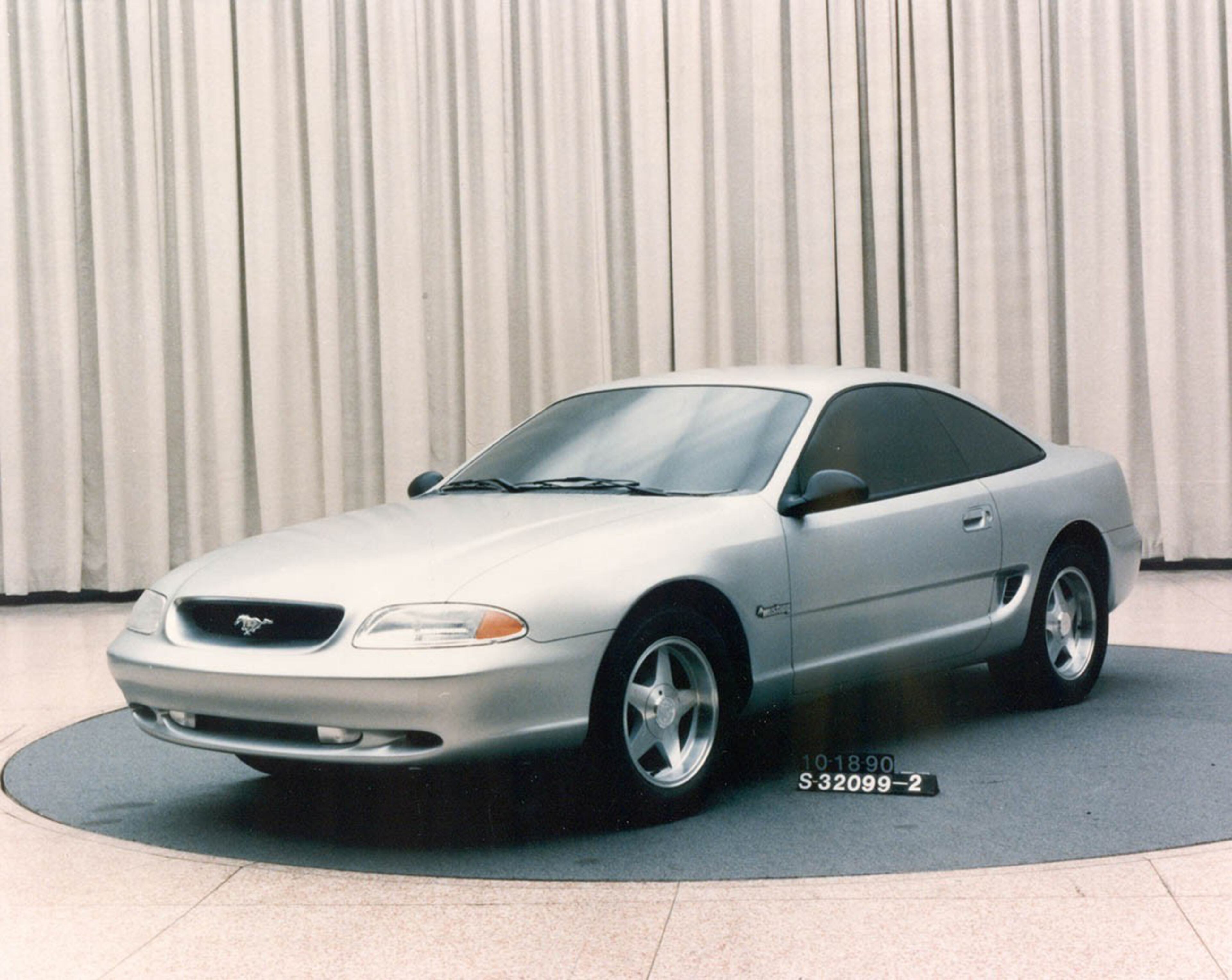 In 1990, Ford designers evaluated a number of themes for a replacement for the long-running third-generation Mustang. The notchback and hatchback bodystyles would be replaced with a single fastback coupe format. After departing from many of the original design cues on the third-generation models, the upcoming fourth-generation would return elements like the galloping pony in the grille, the side scoops and the tri-bar taillamps. This softer concept, known as “Bruce Jenner” wasn’t considered aggressive enough to be a Mustang.