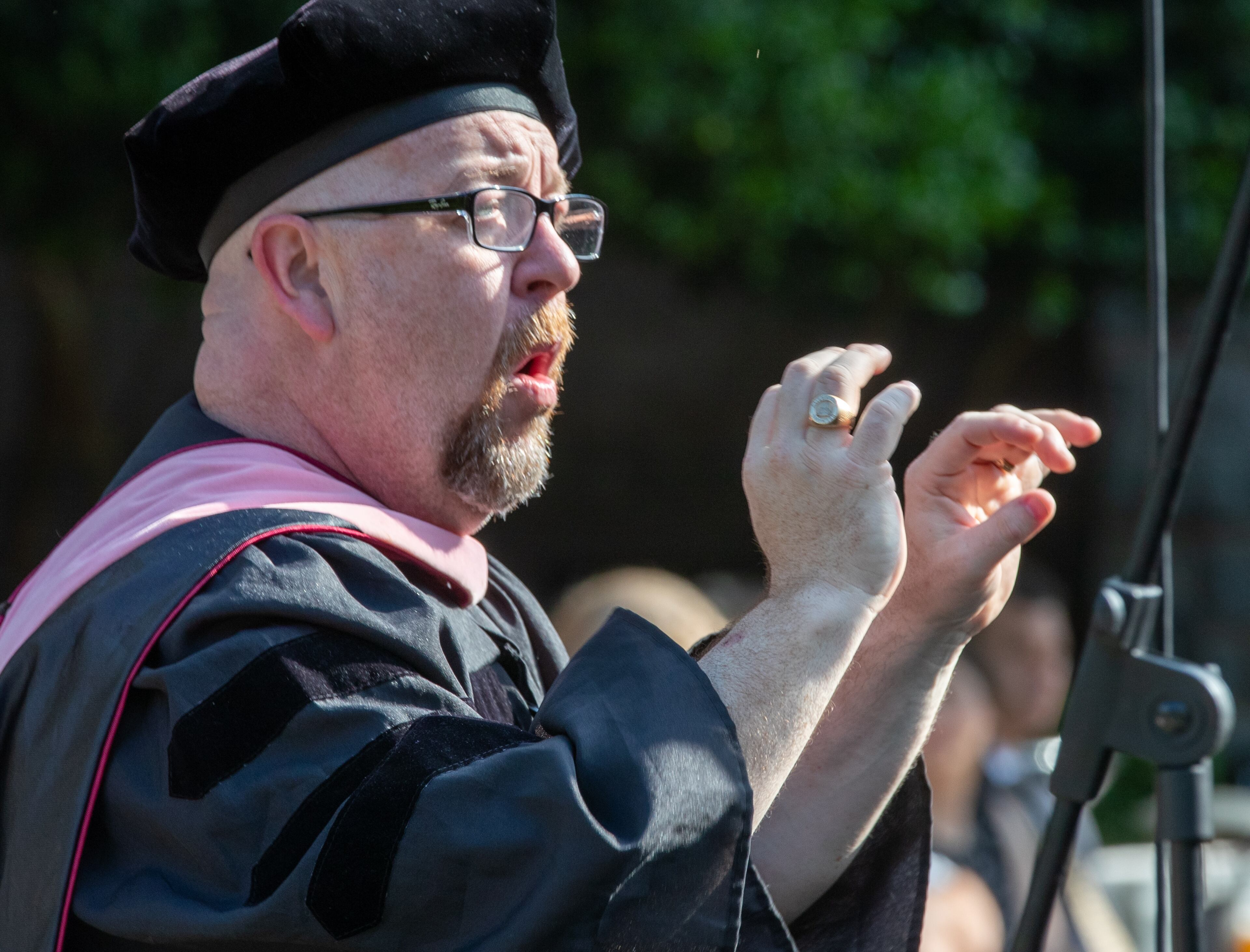 Timothy Powell Leads the choir in a song during Oglethorpe University's Class of 2022 commencement ceremony in the Academic Quadrangle on Saturday, May 21, 2022. (Steve Schaefer / steve.schaefer@ajc.com)