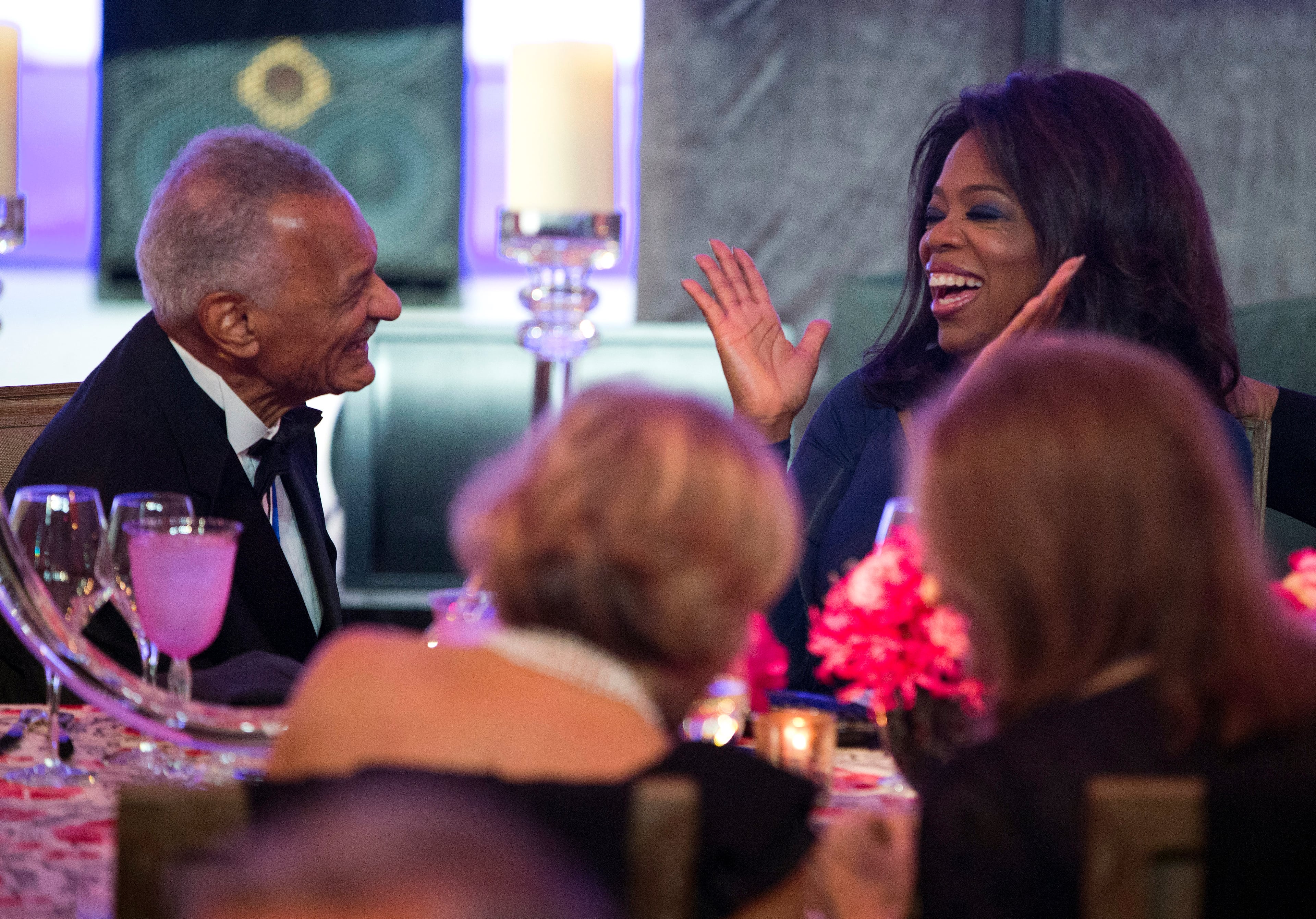 Presidential Medal of Freedom honorees Cordy Tindell, C.T. Vivian, left, and Oprah Winfrey talk before President Barack Obama speaks at a dinner in honor of the Presidential Medal of Freedom awardees.
