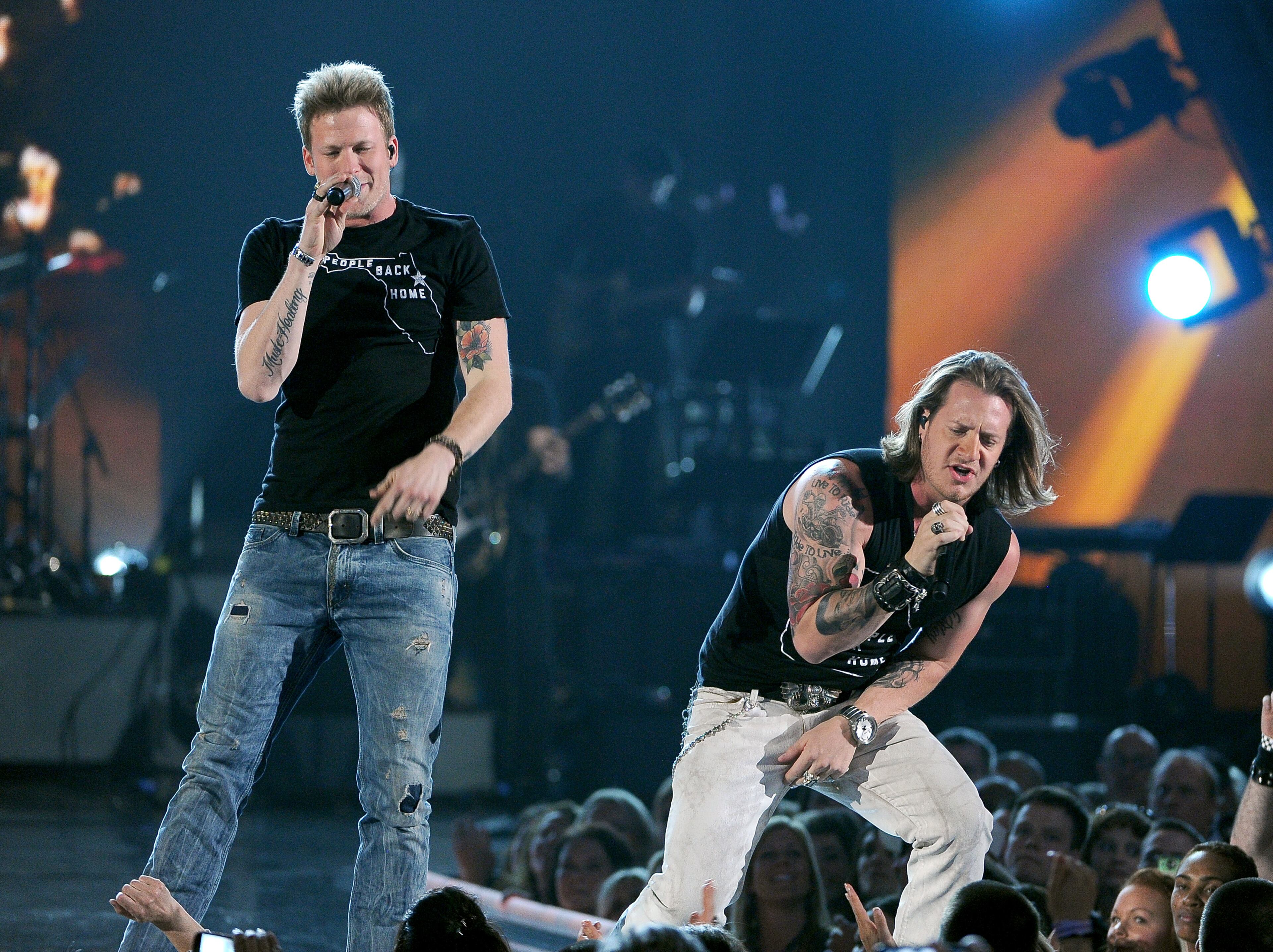 Brian Kelley, left, and Tyler Hubbard, of the musical group Florida Georgia Line, perform at ACM Presents an All-Star Salute to the Troops on Monday, April 7, 2014, in Las Vegas. (Photo by Chris Pizzello/Invision/AP)