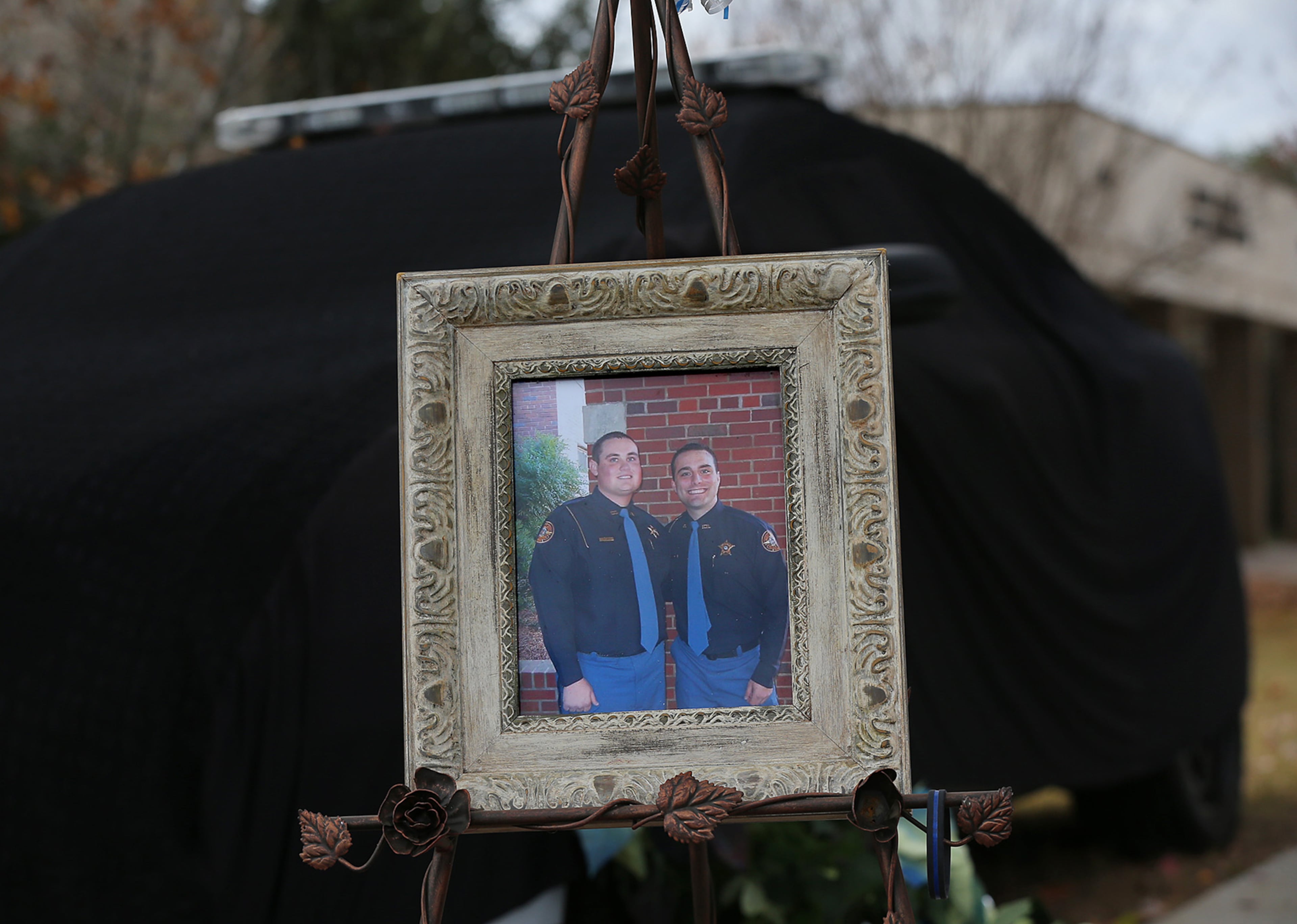 December 11, 2016, AMERICAS: A memorial for Americus police officer Nicholas Ryan Smarr, his patrol car covered in black, and Georgia Southwestern State University campus police officer Jody Smith, sits outside the Russell Thomas, Jr., Public Safety Building on Sunday, Dec. 11, 2016, in Americas. Officer Smarr and officer Smith, seen in the photo placed at the memorial, were killed responding to a domestic dispute. The two officers were longtime friends. Curtis Compton/ccompton@ajc.com